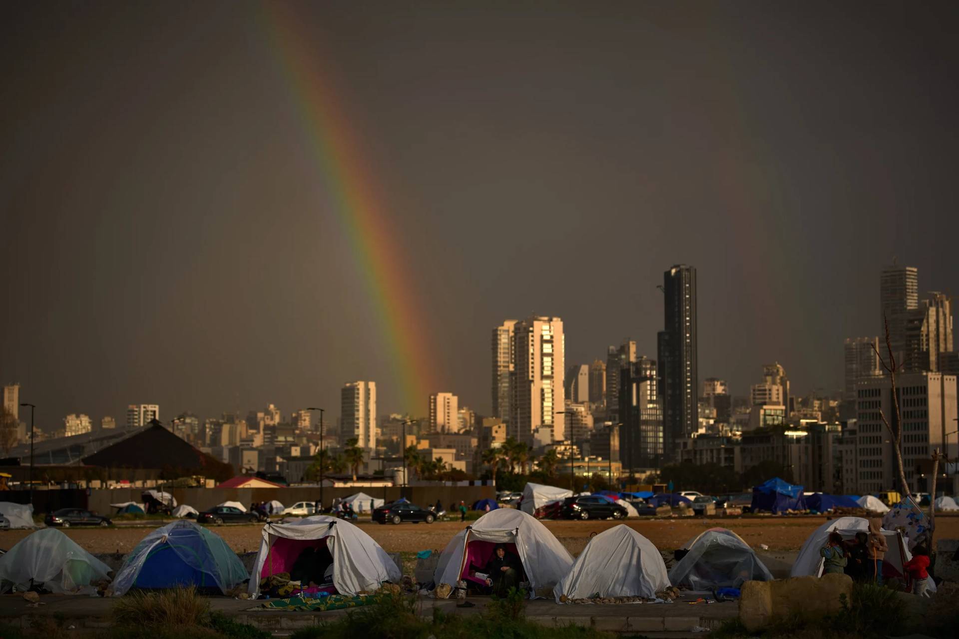 Displaced people who fled Israeli attacks in southern Lebanon sit i n tents in Beirut, Lebanon, on March 29, 2026. (Credit: Emilio Morenatti/AP.)