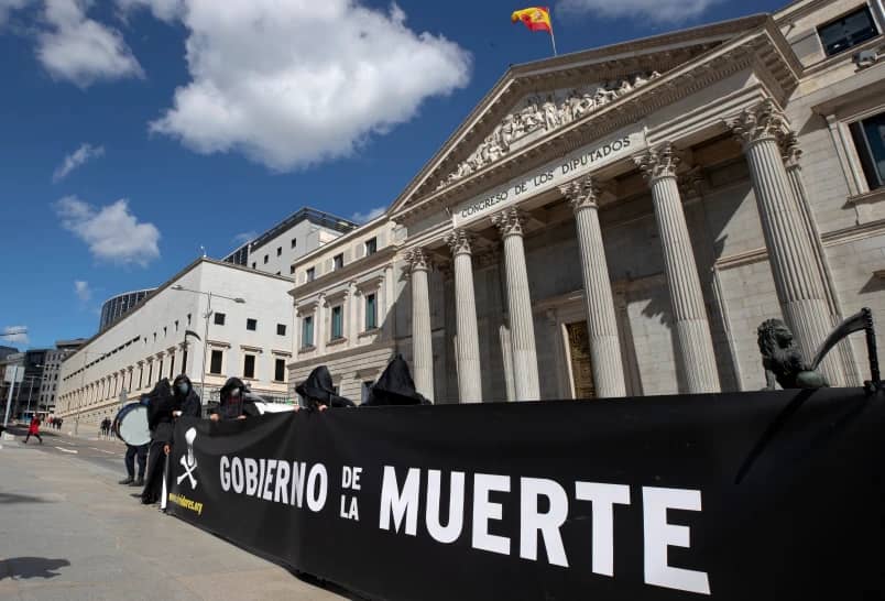 Pro-life protesters stand outside the Spanish Parliament in Madrid, Spain, March 18, 2021. Banner in Spanish reads: ‘Government of Death’. (Credit: Paul White/AP.)