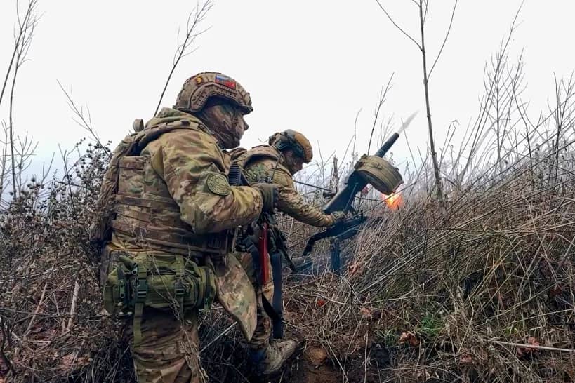 In this image made from video provided by Russian Defense Ministry Press Service on Tuesday, March 31, 2026, Russian soldiers fire a grenade launcher towards Ukrainian positions on an undisclosed location in Ukraine. (Credit: Russian Defense Ministry Press Service via AP.)
