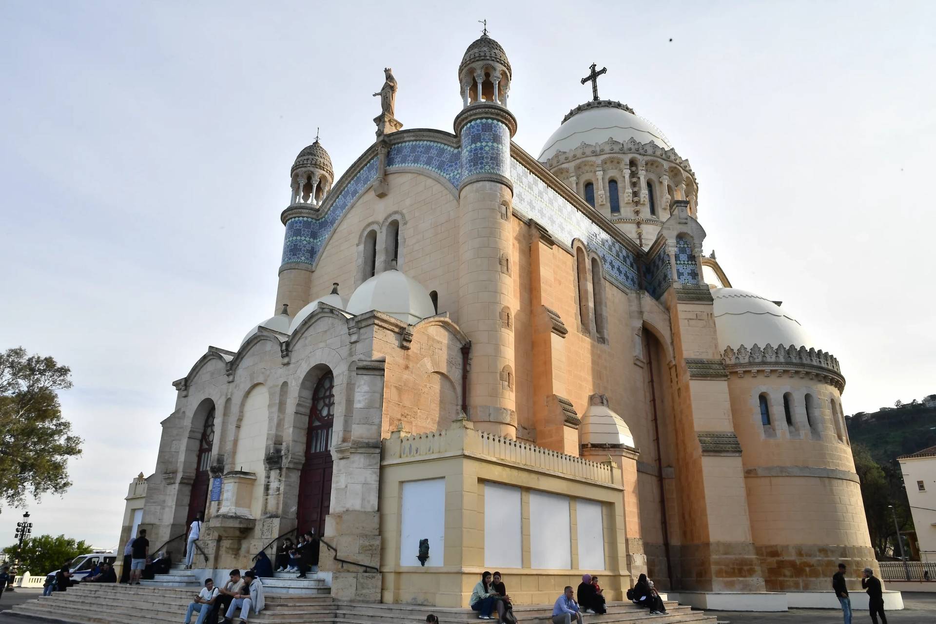 People sit outside the Church of Notre Dame d’Afrique, ahead of Pope Leo XIV’s visit, in Algiers, Algeria, Wednesday, April 8, 2026. (Credit: Fateh Guidoum/AP.)