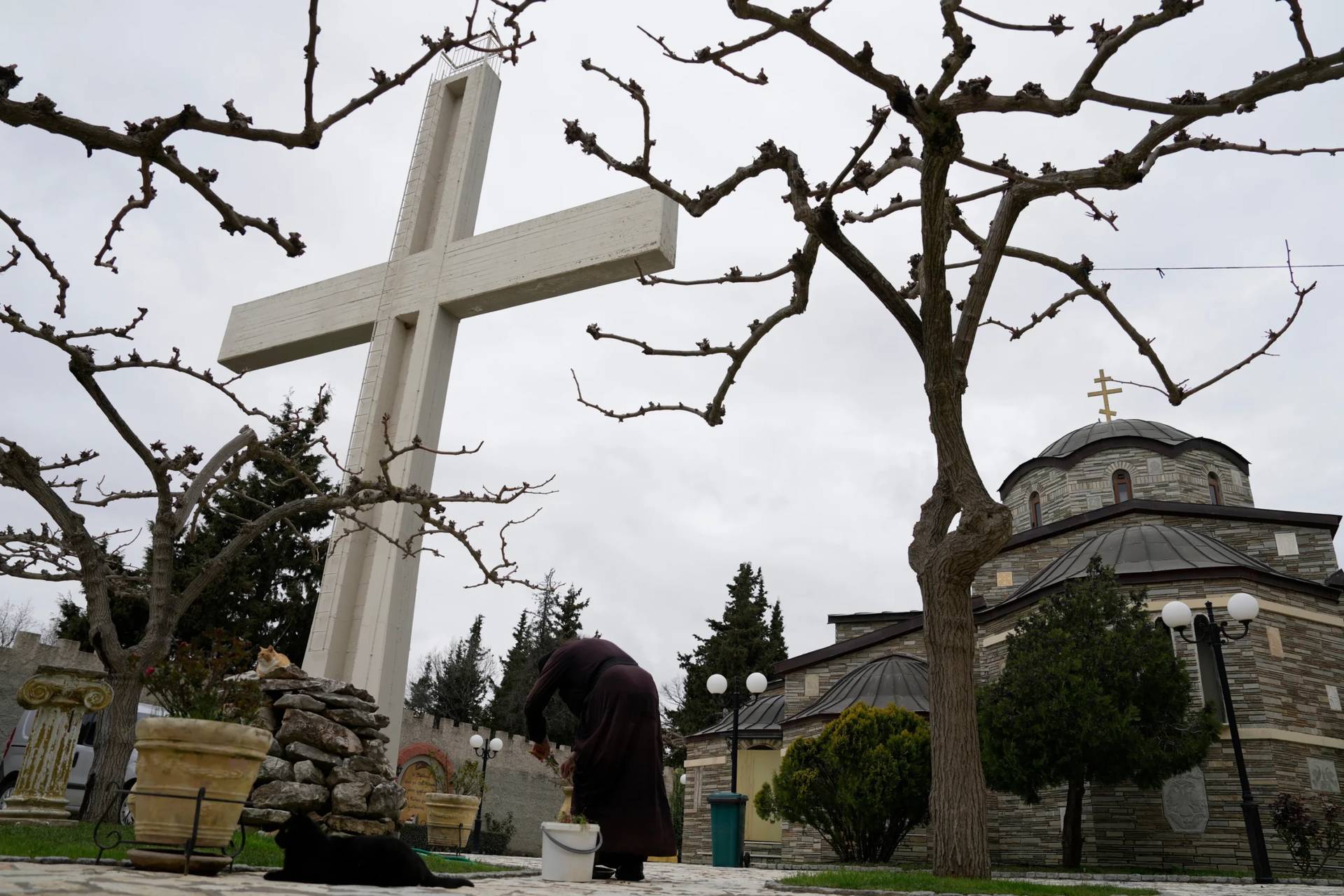 A monk tends to plants at the Monastery of St. Augustine and Seraphim of Sarov in the village of Trikorfo, about 236 kilometers (147 miles) northwest of Athens, Friday, March 20, 2026. (Credit: Thanassis Stavrakis/AP.)