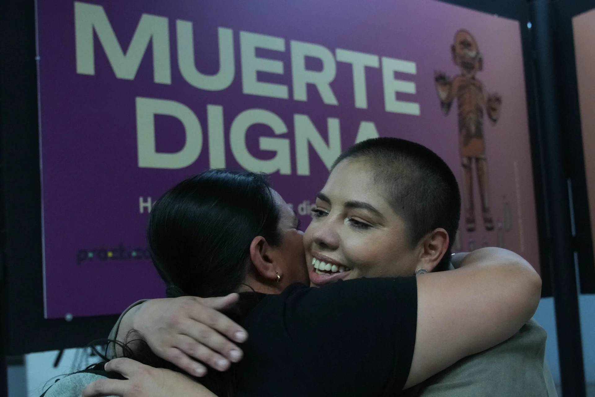 Samara Martínez, a supporter of legalizing euthanasia, hugs a friend in support of the “Muerte Digna” law in Mexico City on March 23, 2026. (Credit: Marco Ugarte/AP.)