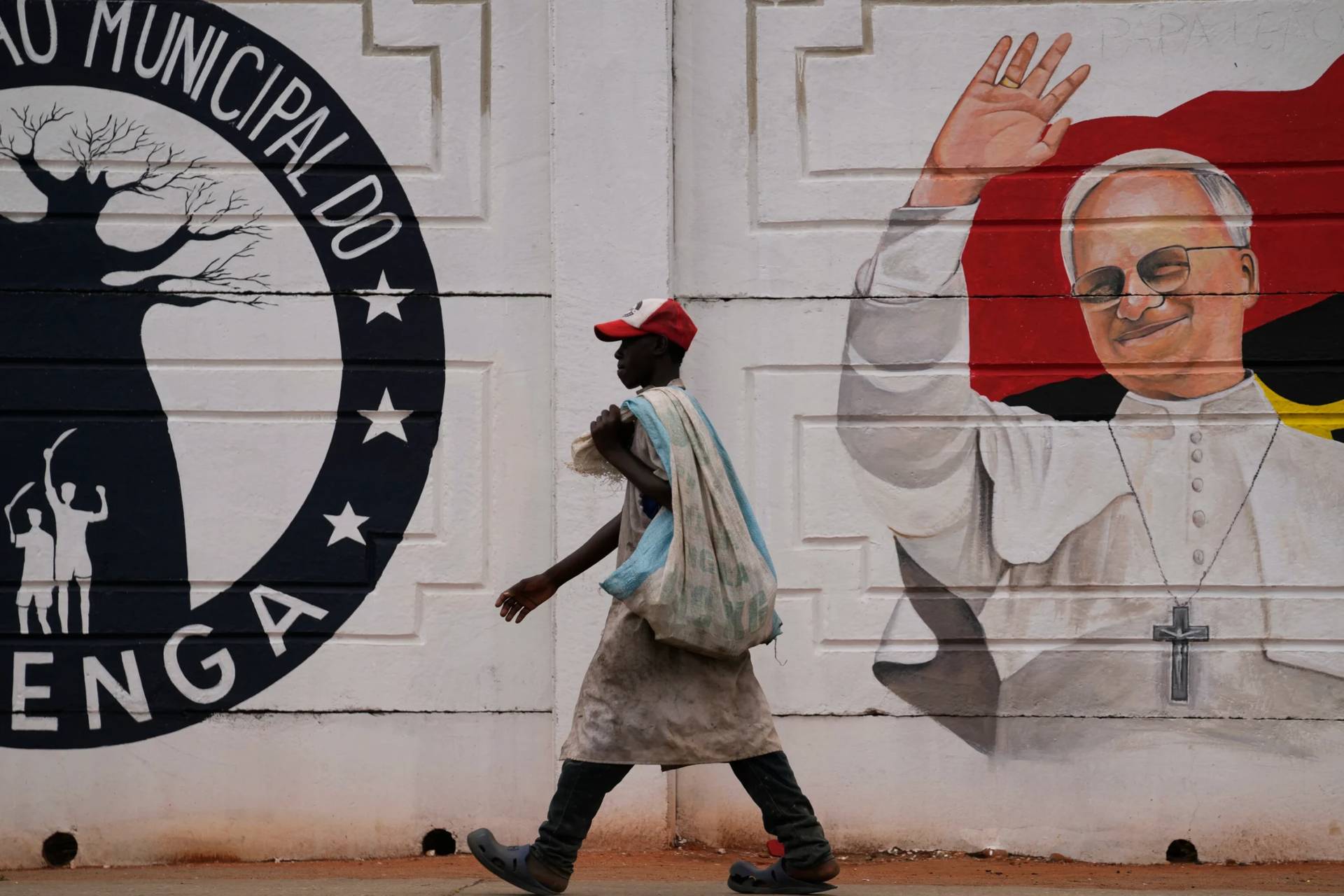 A man walks past a mural of Pope Leo XIV in Luanda, South Africa, Thursday, April 16, 2026. (Credit: Themba Hadebe/AP.)