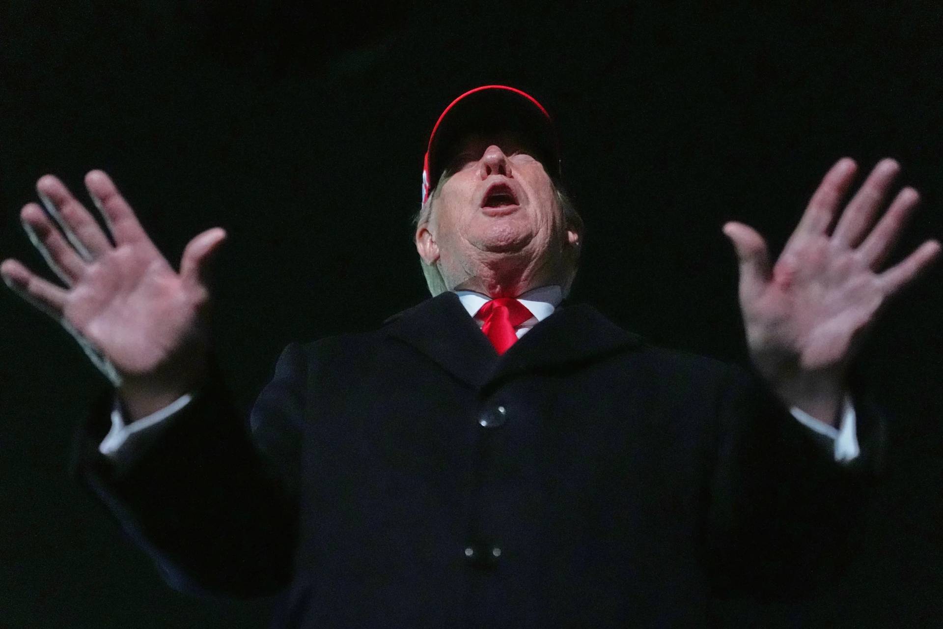 President Donald Trump speaks with reporters at Joint Base Andrews, Maryland, on April 12, after leaving Miami. (Credit: Julia Demaree Nikhinson/AP.)