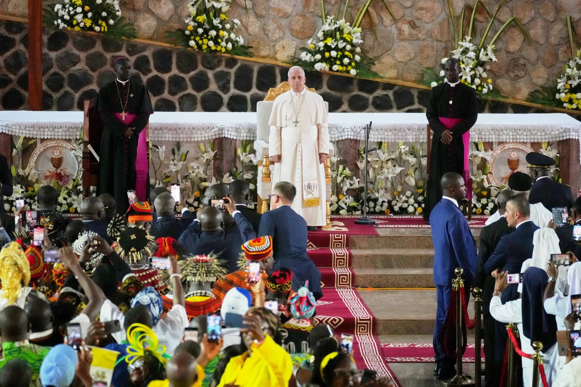 Pope Leo XIV, with the Archbishop of Bamenda Andrew Nkea Fuanya, left, leads a meeting for peace at Saint Joseph's Cathedral in Bamenda, Cameroon, with the local community Thursday, April 16, 2026, on the fourth day of his 11-day pastoral visit to Africa. (Credit: Andrew Medichini/AP.)
