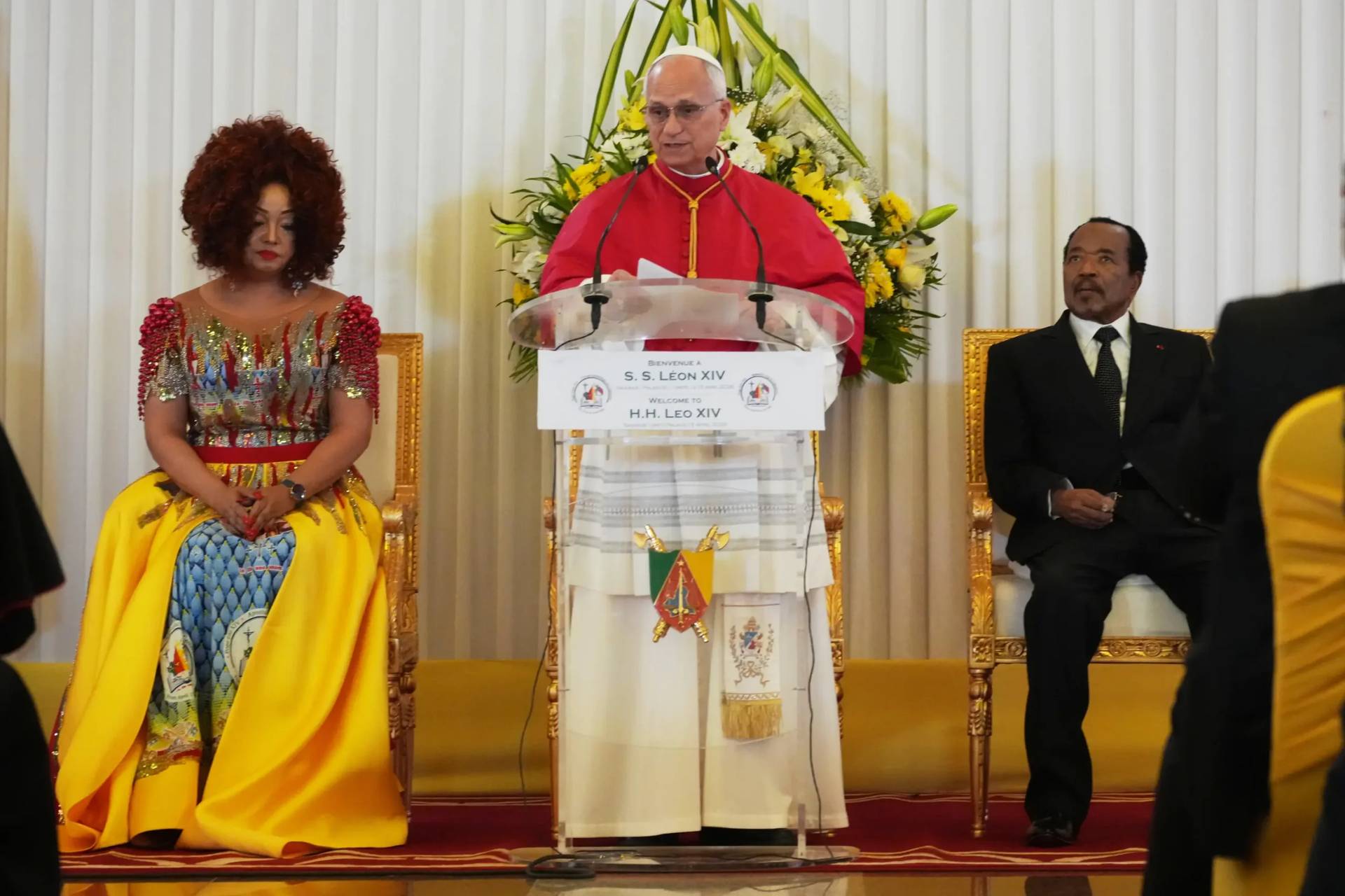 Pope Leo XIV, center, flanked by Cameroon’s President Paul Biya and his wife Chantal, meets with the authorities, civil society and the diplomatic corps in Yaounde Cameroon, Wednesday, April 15, 2026. (Credit: Andrew Medichini/AP.)