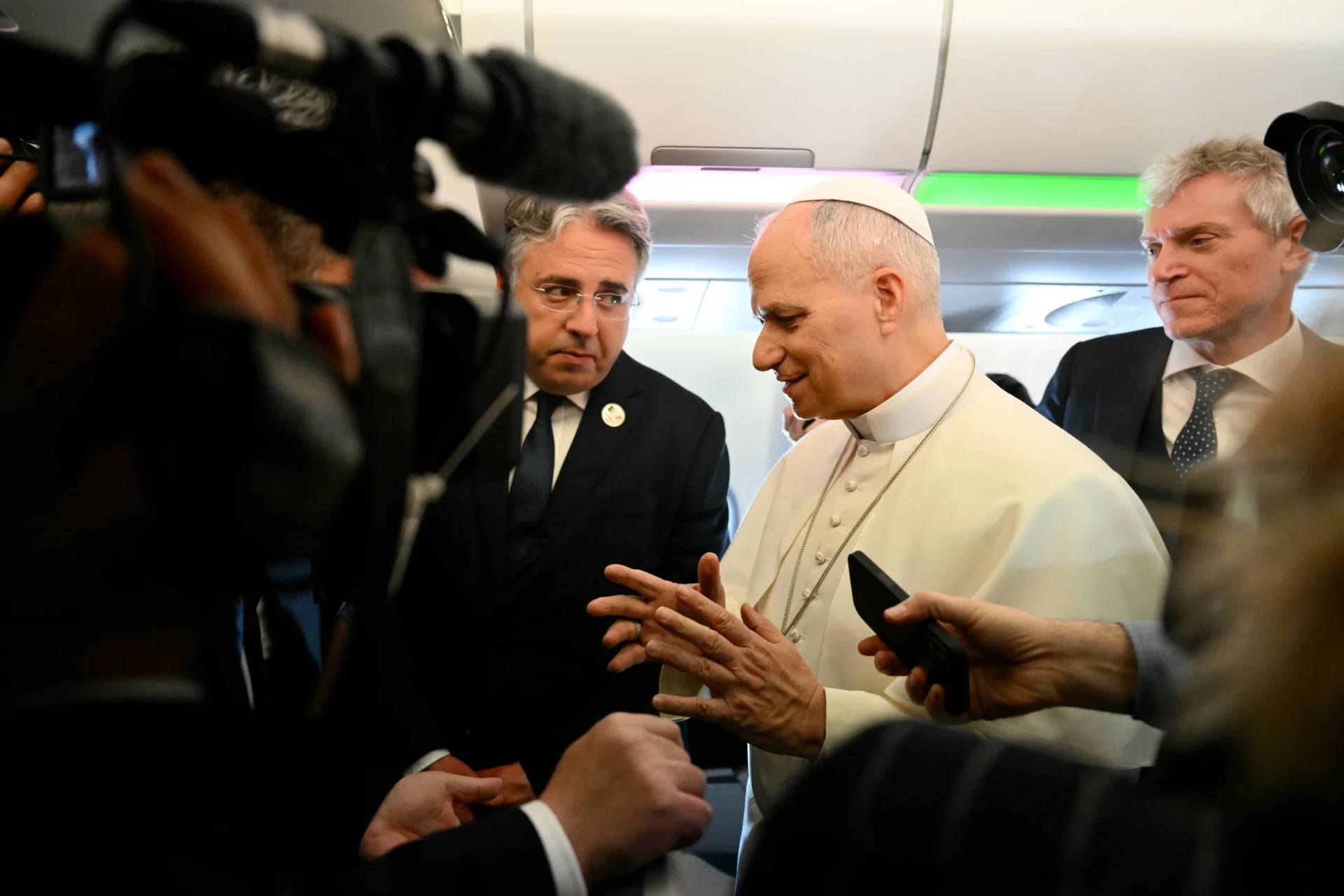 Pope Leo XIV speaks to journalists aboard his flight bound for Algiers’ Houari Boumédiène International Airport on Monday, April 13, 2026, at the start of an 11-day apostolic journey to Africa. (Credit: Alberto Pizzoli/Pool Photo via AP.)