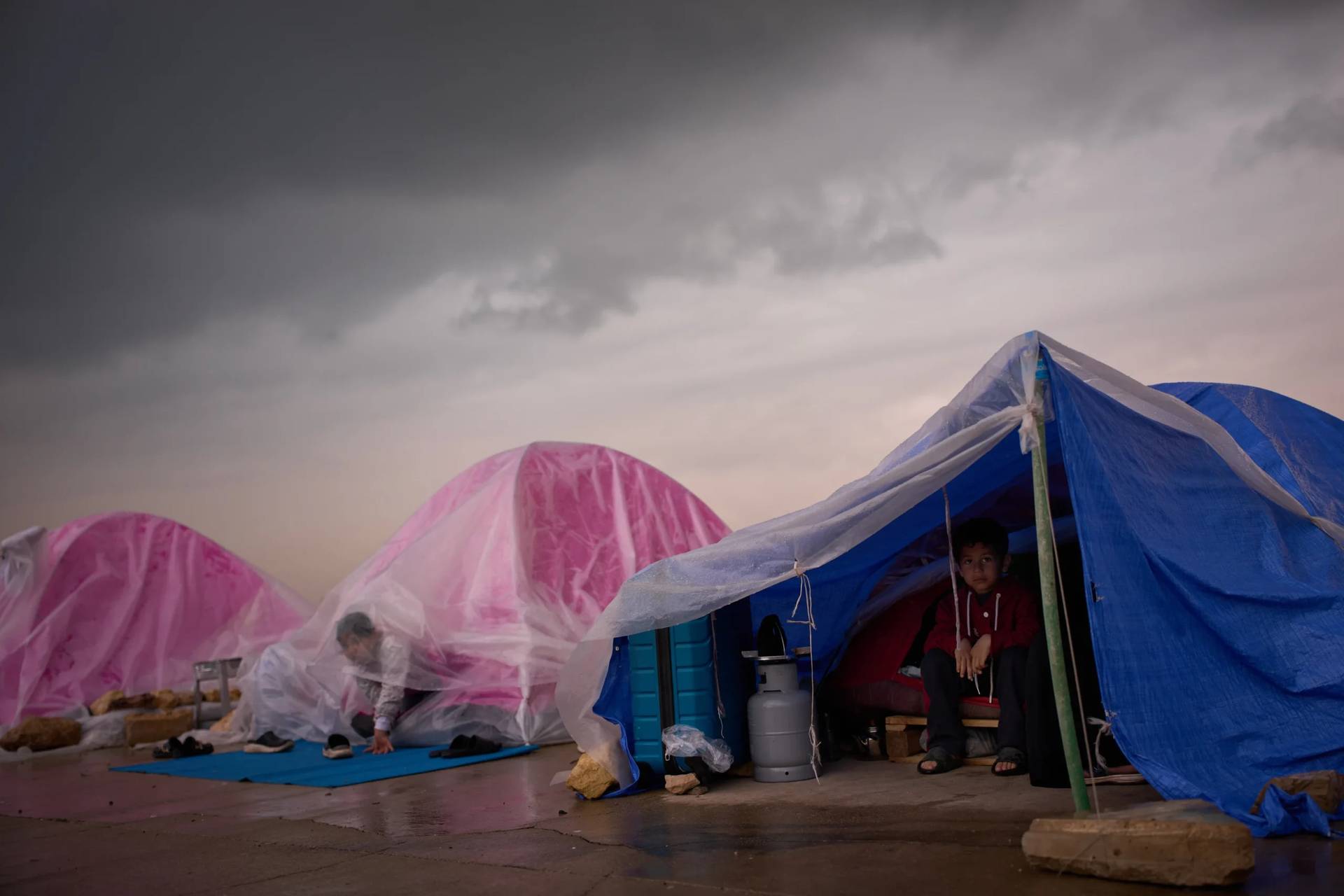 Zahra, 6, displaced from Beirut’s southern suburb of Dahiyeh, sits inside a tent used as a shelter along the beachfront in Beirut, Lebanon, Thursday, March 26, 2026. (Credit: Emilio Morenatti/AP.)