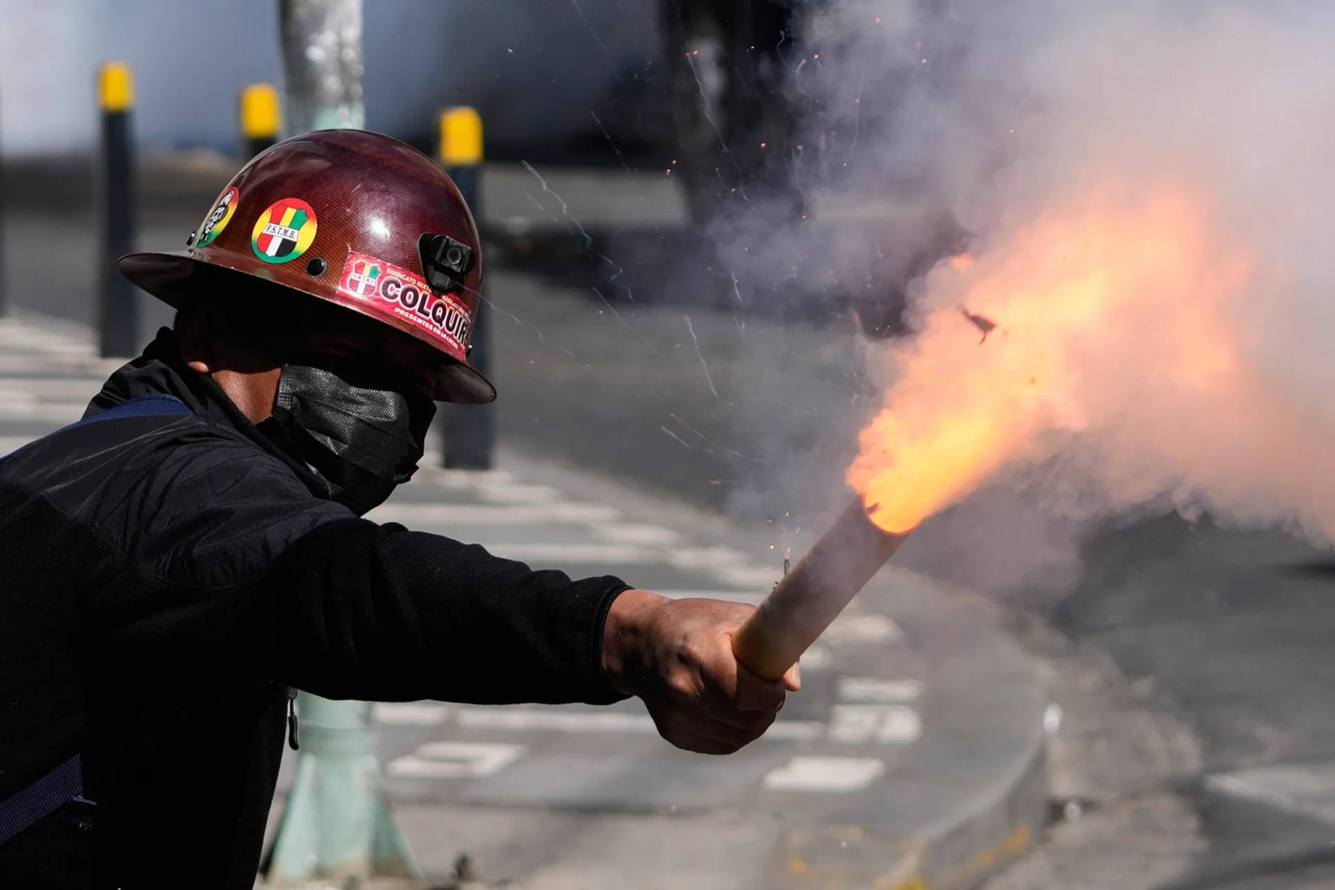 A miner launches a firecracker at police during an anti-government protest in La Paz, Bolivia, Monday, May 18, 2026. (Credit: Juan Karita/AP.)