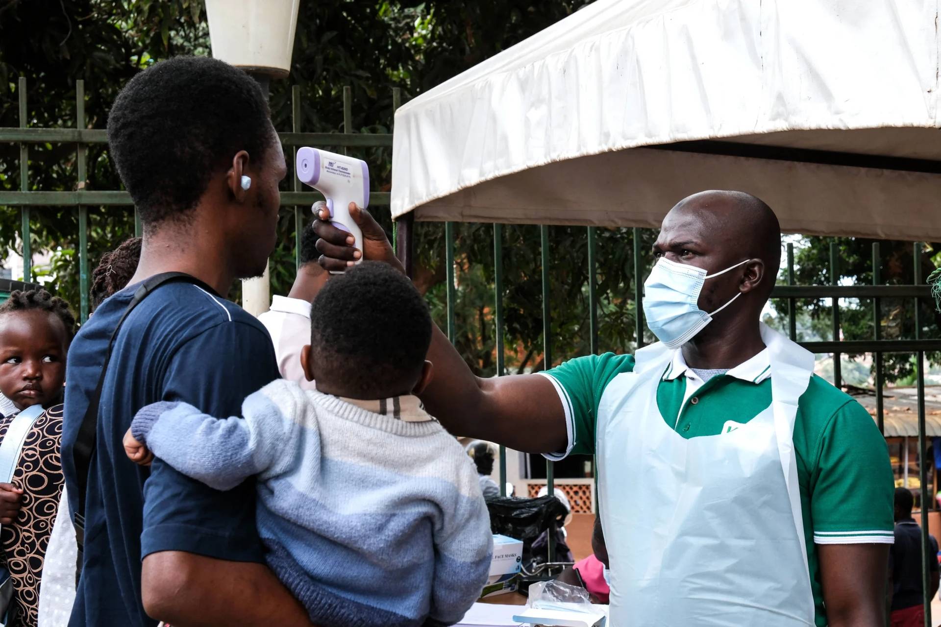 A health official uses a thermometer to screen people in front of Kibuli Muslim Hospital in Kampala, Uganda, Saturday, May 16, 2026. (Credit: Hajarah Nalwadda/AP.)