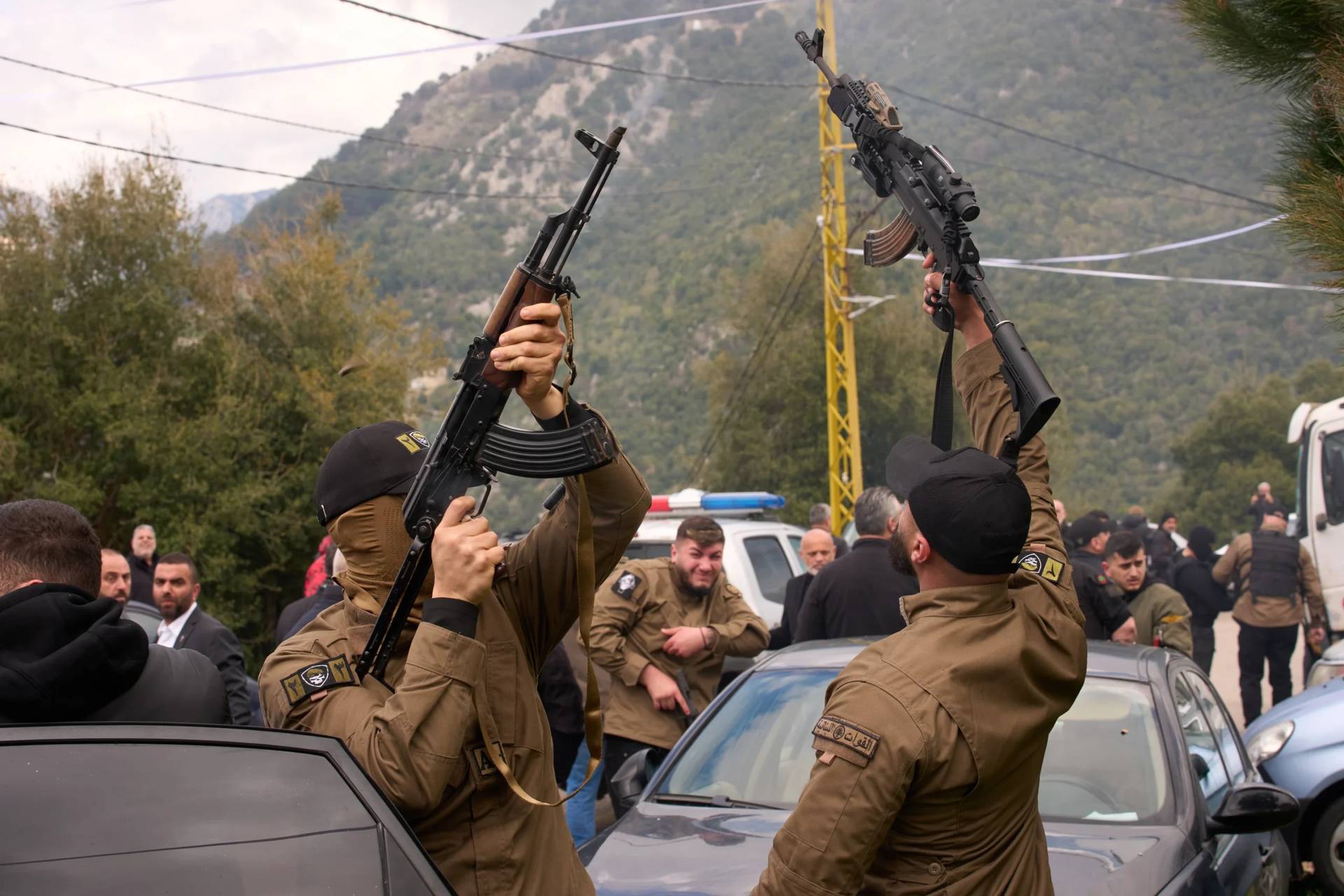Gunmen fire their weapons as men carry the coffins with the bodies of Pierre Mouawad, an official with the anti-Hezbollah Lebanese Forces party, and his wife during their funeral in Yahshush, in Lebanon, Tuesday, April 7, 2026. (Credit: Emilio Morenatti/AP.)