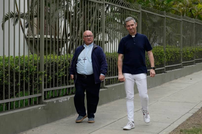 Vatican investigators Monsignor Jordi Bertomeu, right, from Spain, and Archbishop Charles Scicluna, from Malta, walk outside of the Nunciatura Apostolica during a break from meeting with people who alleged abuse by the Catholic lay group Sodalitium Christianae Vitae in Lima, Peru, on July 25, 2023. (Credit: Martin Mejia/AP.)