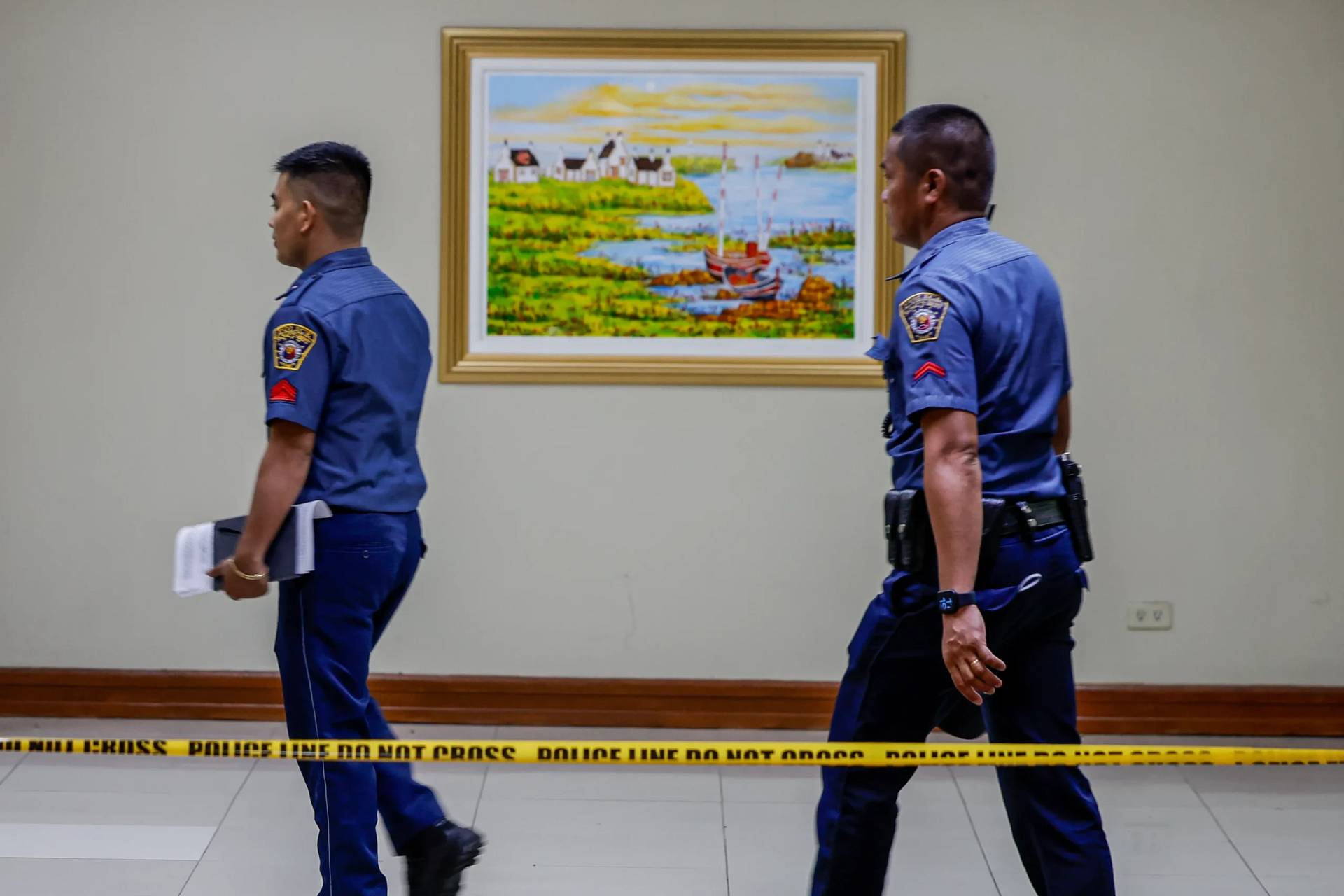 Police walk behind a cordon-offed area inside the Philippine Senate premises in Parsay City on May `14, 2026. (Credit: Gerard Carreon/AP.)