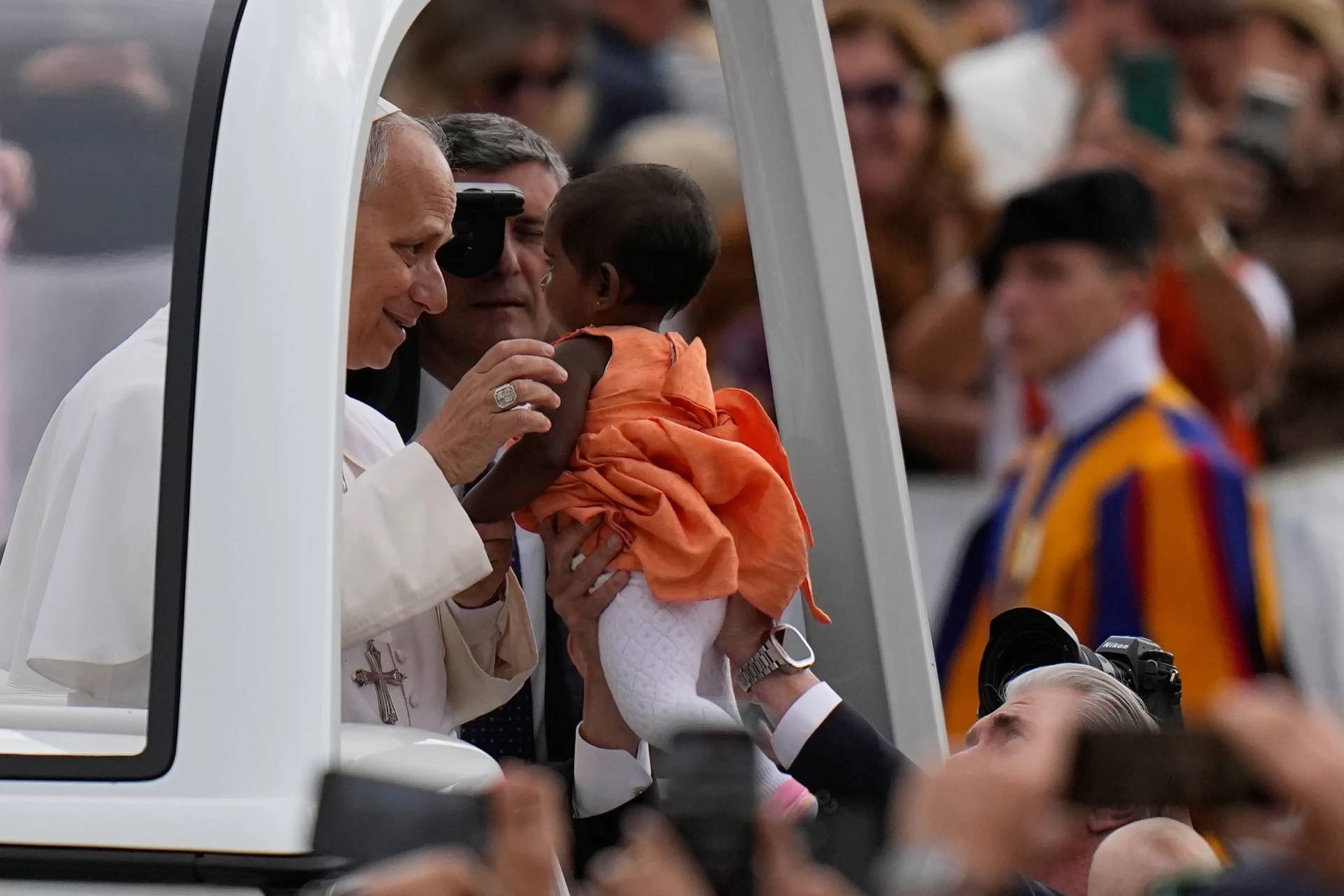 Pope Leo XIV blesses a little girl as he arrives for his weekly general audience in St. Peter's Square, at the Vatican, Wednesday, May 13, 2026. (Credit: Alessandra Tarantino/AP.)