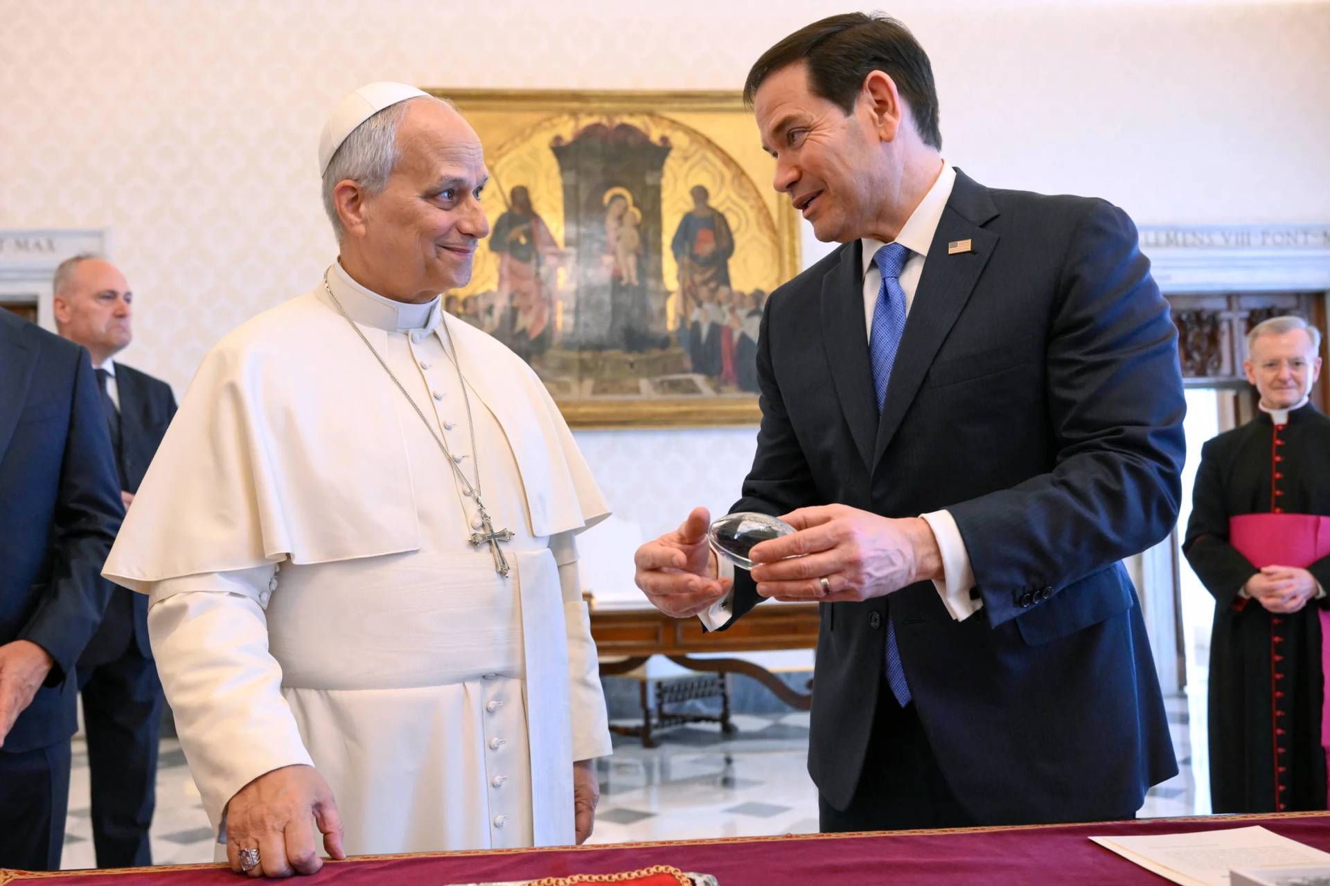 In this handout photo provided by Vatican Media Pope Leo XIV exchanges gifts with U.S. Secretary of State Marco Rubio, right, as they meet in the pope’s private library at the Vatican, Thursday, May 7, 2026. (Credit: Vatican Media via AP.)