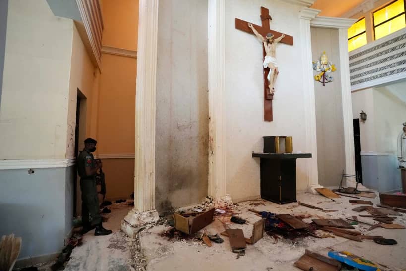 A police officer stands guard inside the St. Francis Catholic Church, a day after an attack that targeted worshipers in Owo, Nigeria, June 6, 2022. (Credit: Sunday Alamba/AP.)