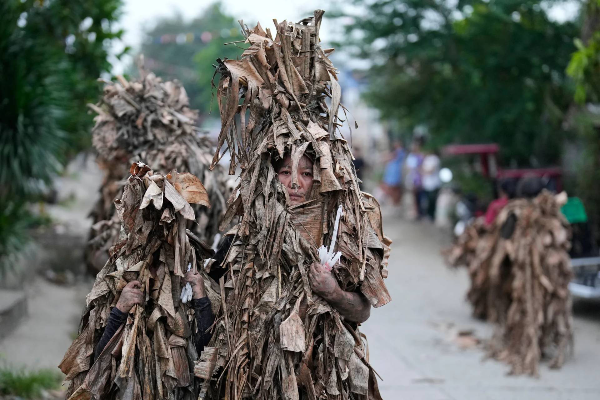 Catholics covered in mud and dried banana leaves join the mud people festival on the feast day of Saint John the Baptist at Bibiclat, Nueva Ecija province, northern Philippines on Wednesday, June 24, 2026. (AP Photo/Aaron Favila)
