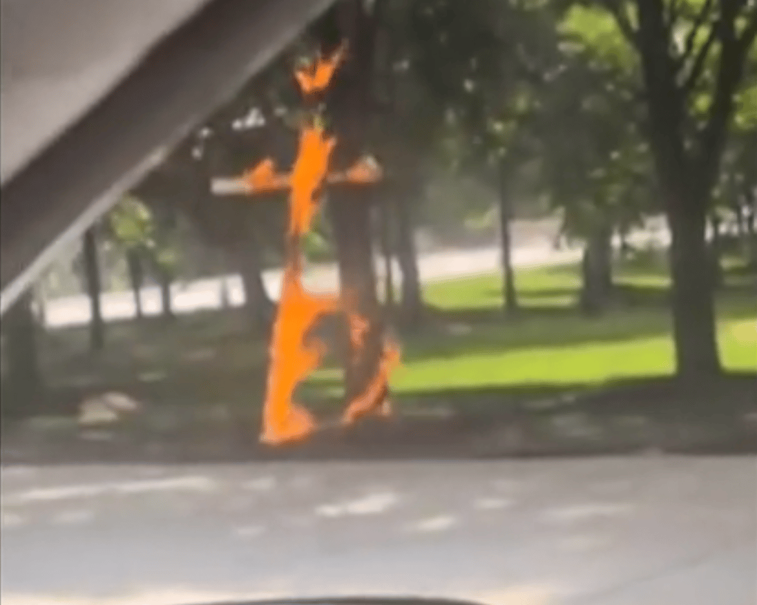 A burning cross near a tree in Grant Park in Chicago, Illinois. (Credit: AP.)