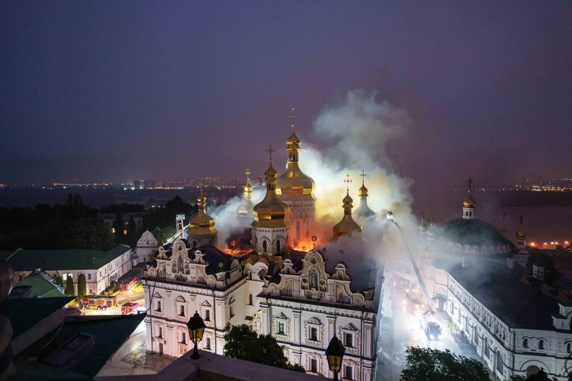 Rescue workers try to put out a fire at the Dormition Cathedral of thousand-year-old Monastery of Caves, also known as Kyiv Pechersk Lavra, following a Russian strike on Kyiv, Ukraine, Monday, June 15, 2026. (Credit: Evgeniy Maloletka/AP.)
