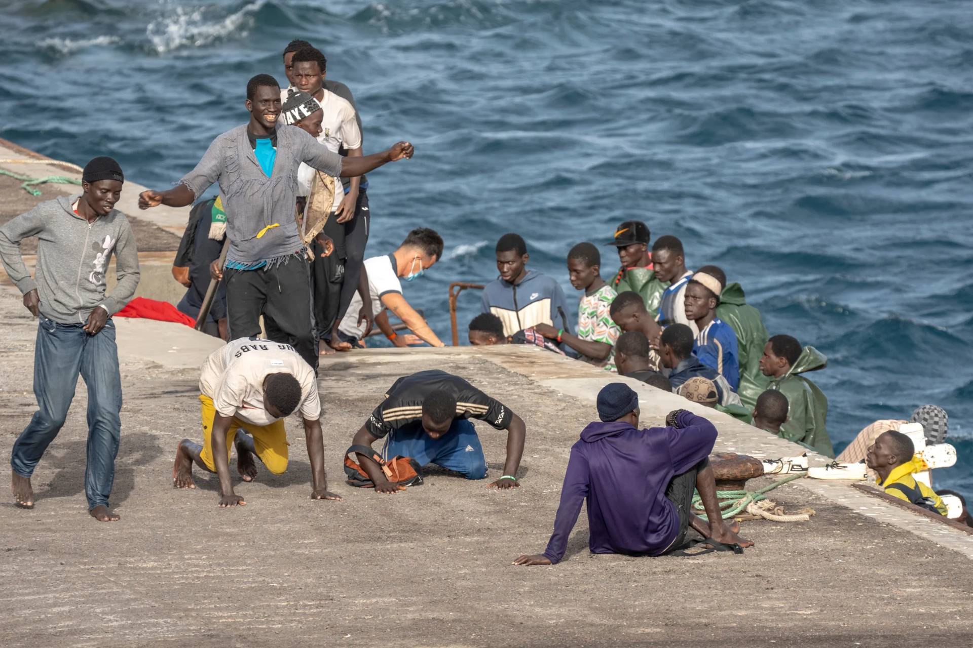 Migrants react as they arrive at the port in La Restinga on the Canary island of El Hierro, Spain, on, Aug. 19, 2024. (Credit: Maria Ximena/AP.)