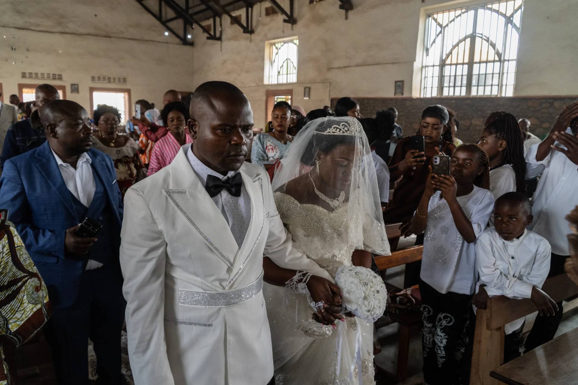 A newly married couple walks down the aisle at their wedding amid an Ebola outbreak in Ituri Province in Bunia, Congo, Saturday, June 6, 2026. (Credit: Moses Sawasawa/AP.)