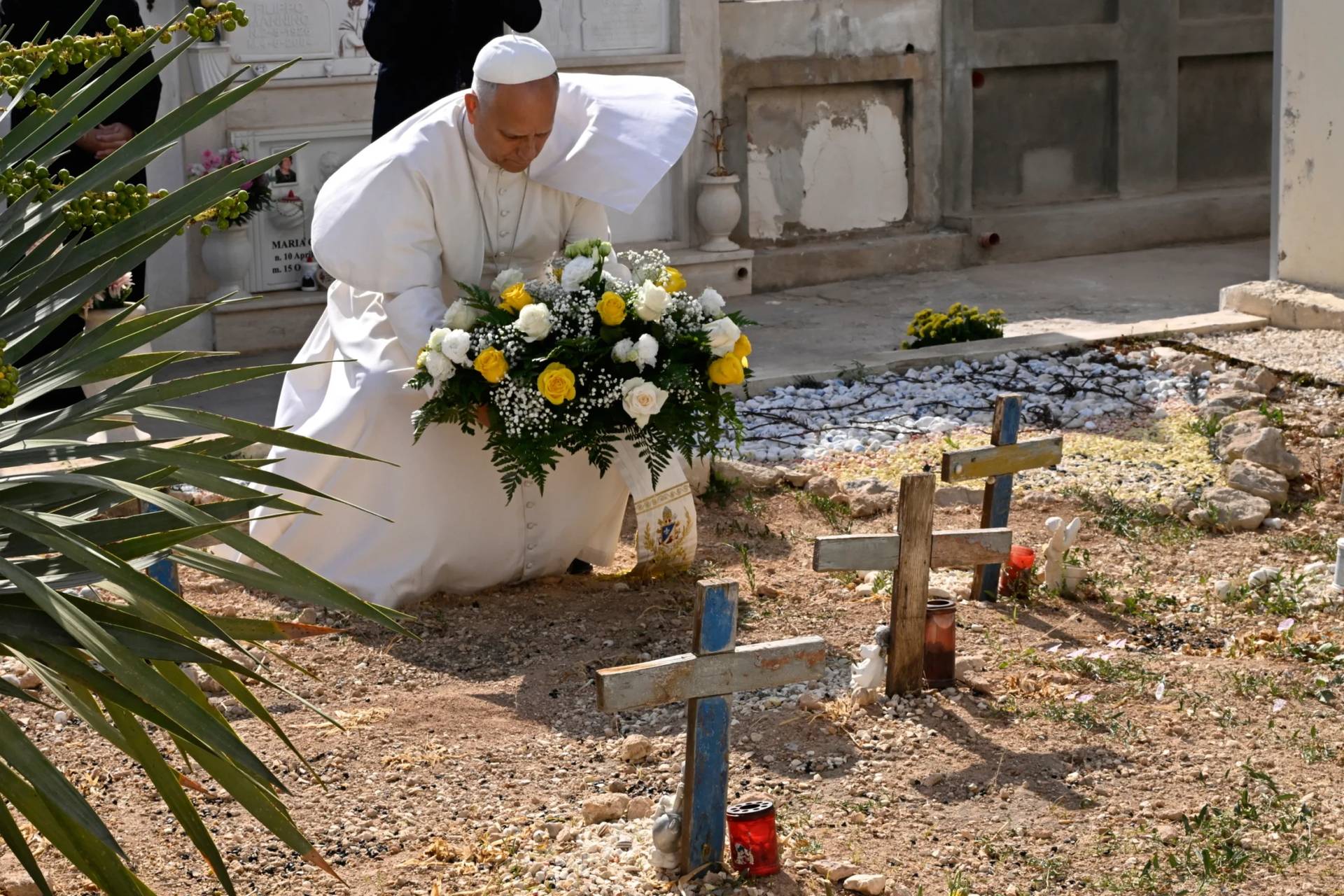 Pope Leo XIV pays tribute at the cemetery and on little Joussef's grave, in Lampedusa, Sicily, southern Italy, Saturday, July 4, 2026, during a one-day pastoral visit to an island that has become a symbol of the risks faced by migrants trying to reach Europe by sea.(Credit: Pool Photo/Ciro Fusco, Via AP.)