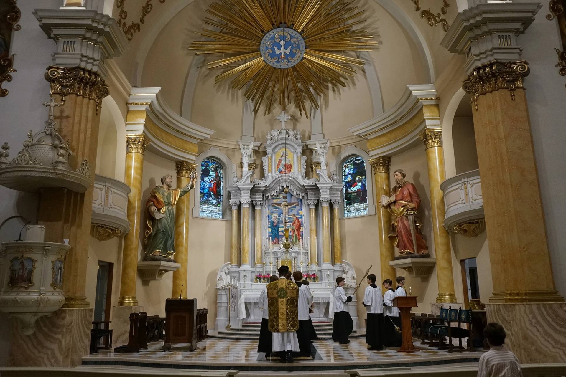 Father John Ubel, pastor of the Church of Saint Agnes, processes into the sanctuary with altar servers at the start of one of the Catholic parish’s Latin Masses in St. Paul, Minn., Sunday, June 28, 2026. (Credit: Giovanna Dell’Orto/AP.)