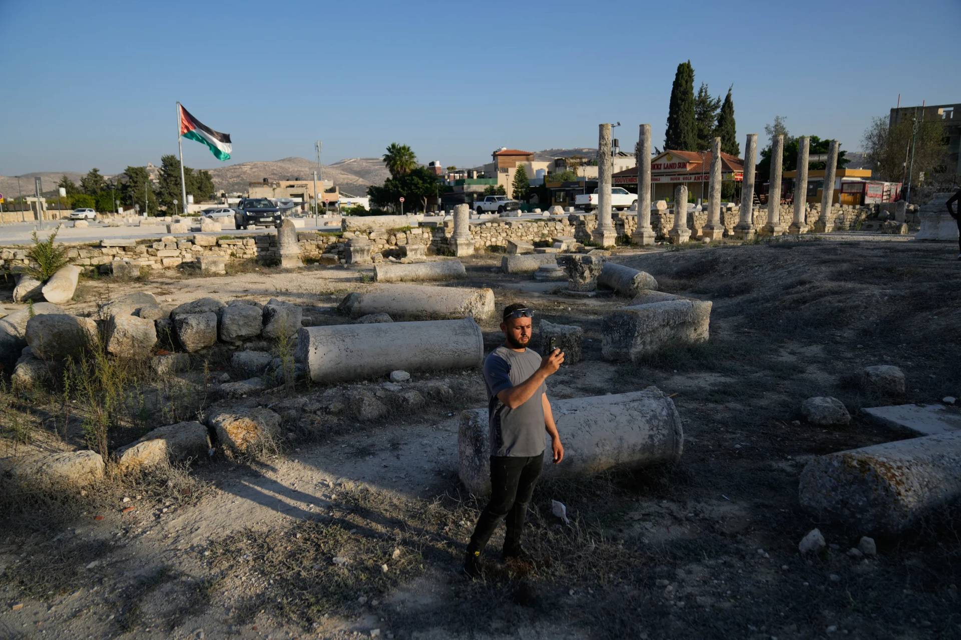 A Palestinian visitor takes a photo at the Roman historical site in the West Bank town of Sebastia on Nov. 20, 2025. (Credit: Nasser Nasser/AP.)