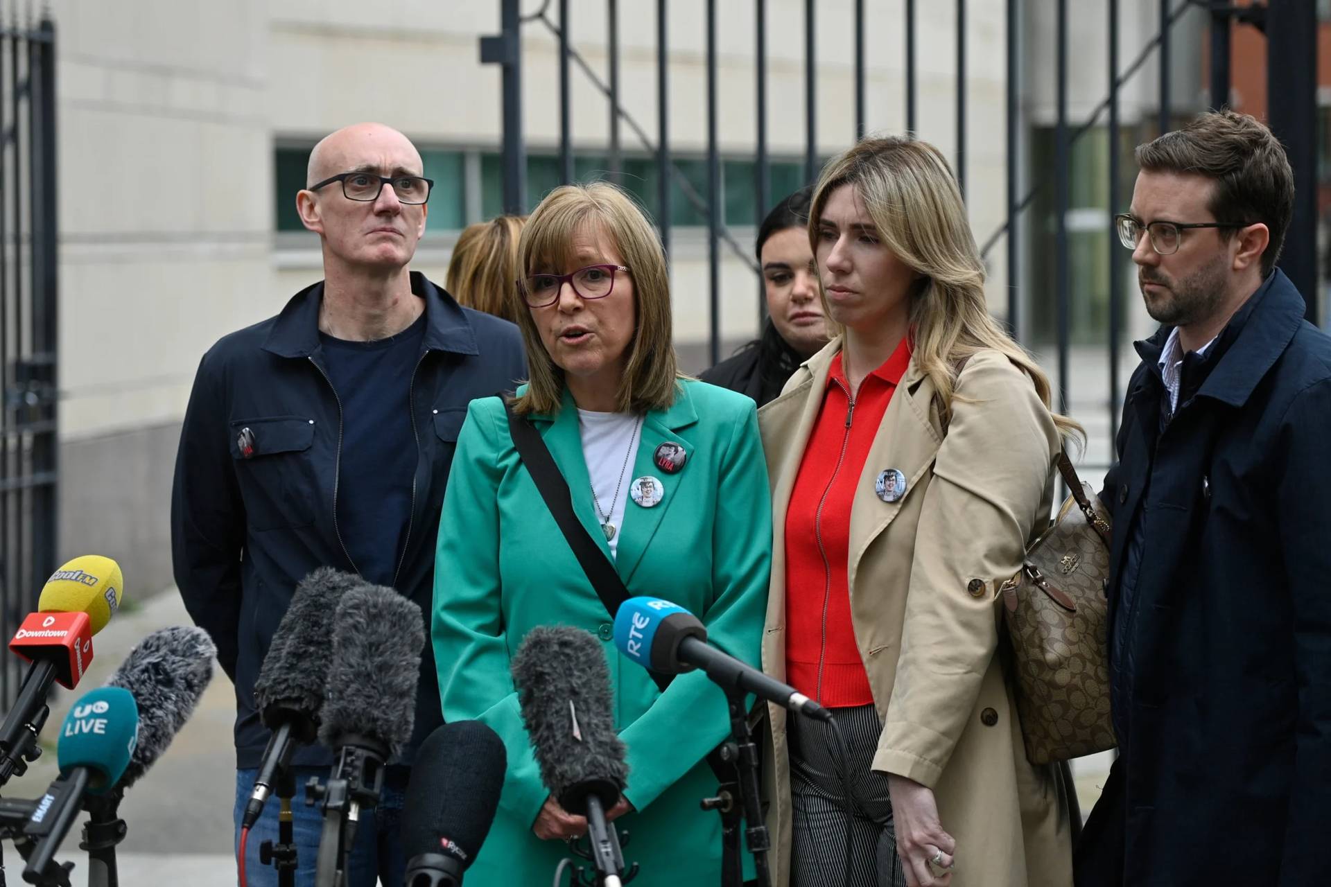 Lyra McKee's sister Nichola Corner, center, speaks to the media outside Belfast Crown Court in Belfast, Northern Ireland, where Paul McIntyre, Peter Cavanagh, and Jordan Gareth Devine have been found not guilty in a non-jury trial of the murder of a journalist Lyra McKee, on July 3, 2026. (Credit: PA via AP.)