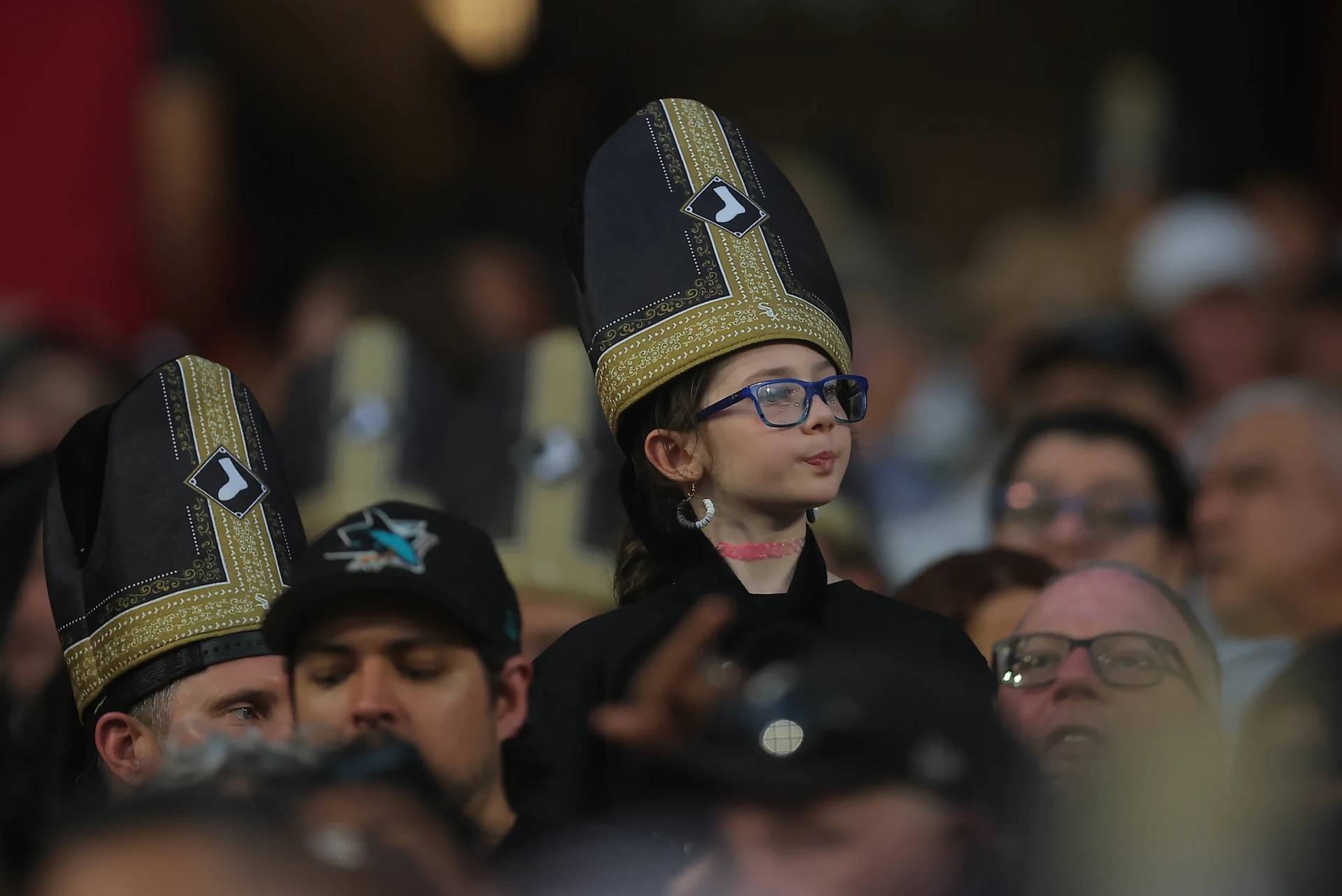 A fan wears a promotional pope hat during a baseball game between the Cincinnati Reds and Chicago White Sox on Aug. 11, 2026 in Chicago, Illinois. (Credit: Melissa Tamez/AP.)