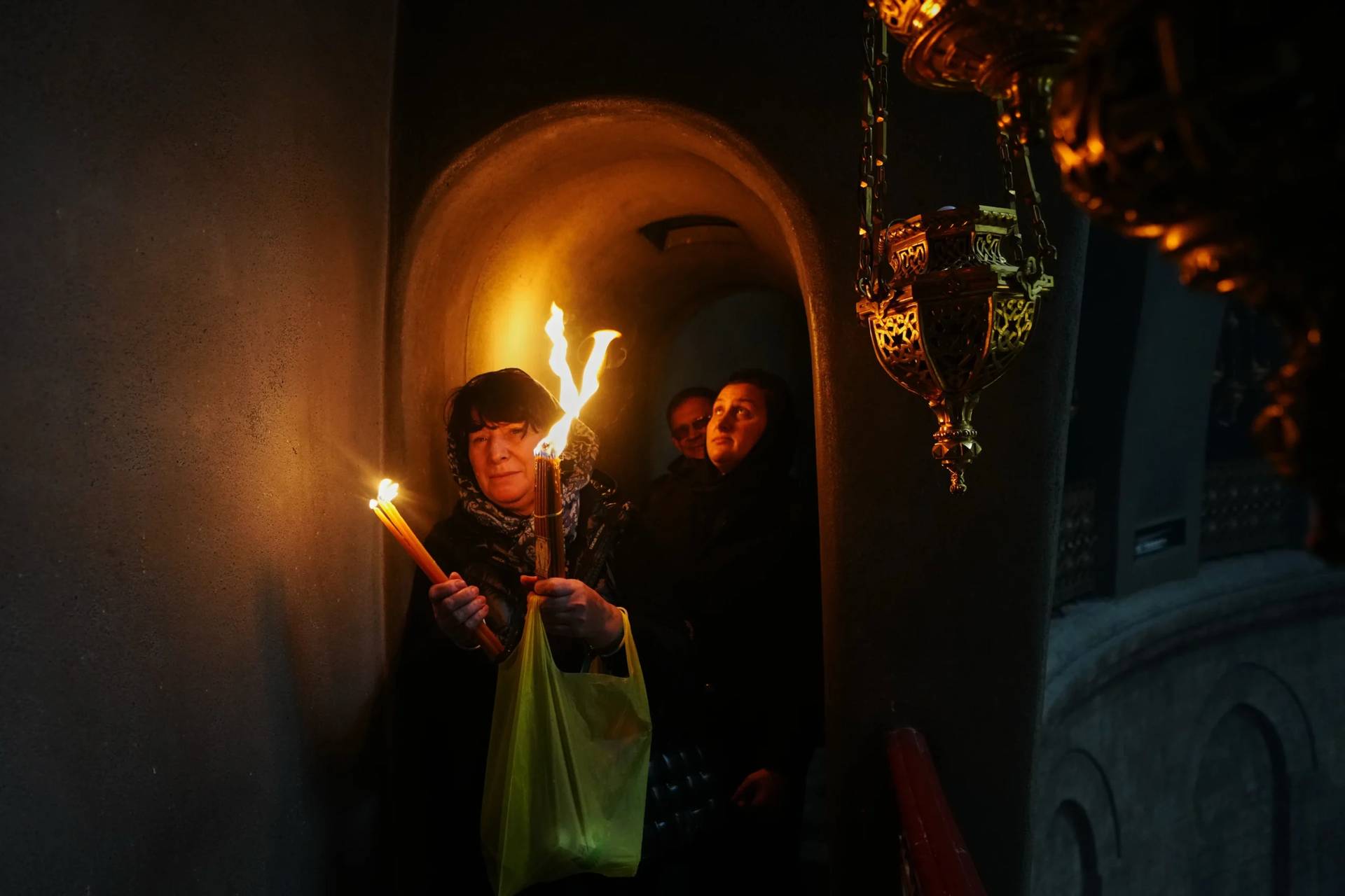 Christian Orthodox pilgrims hold up candles during the Holy Fire ceremony, at the Church of the Holy Sepulcher in the Old City of Jerusalem, Saturday, April 11, 2026. (Credit: Mahmoud Illean/AP.)
