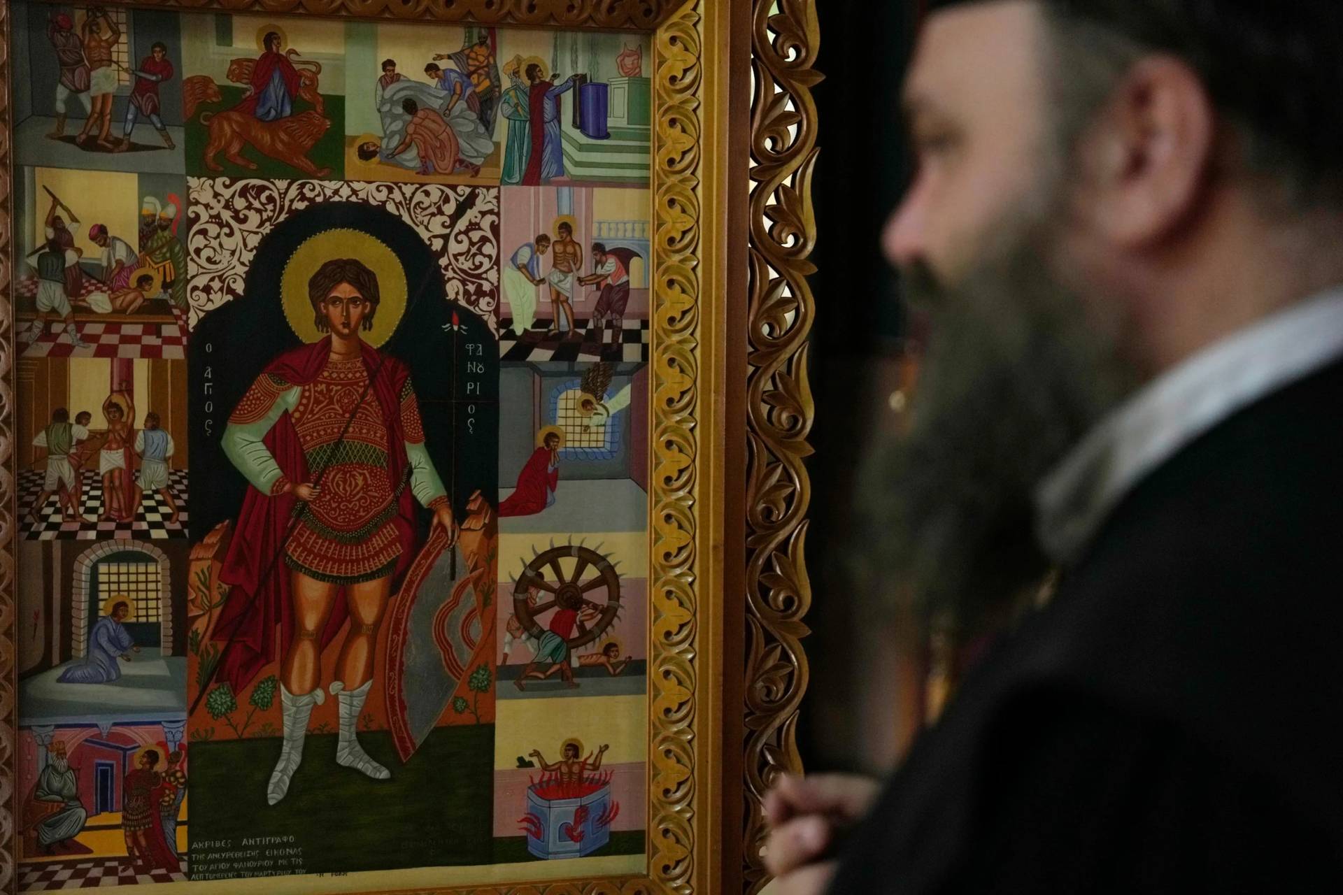 Father Nikolaos Vlavianos stands beside an icon of Saint Fanourios, known in Greek as "The Revealer," at the Church of St. Fanourios in Athens, Tuesday, Aug. 25, 2026. (Credit: Thanassis Stavrakis/AP.)