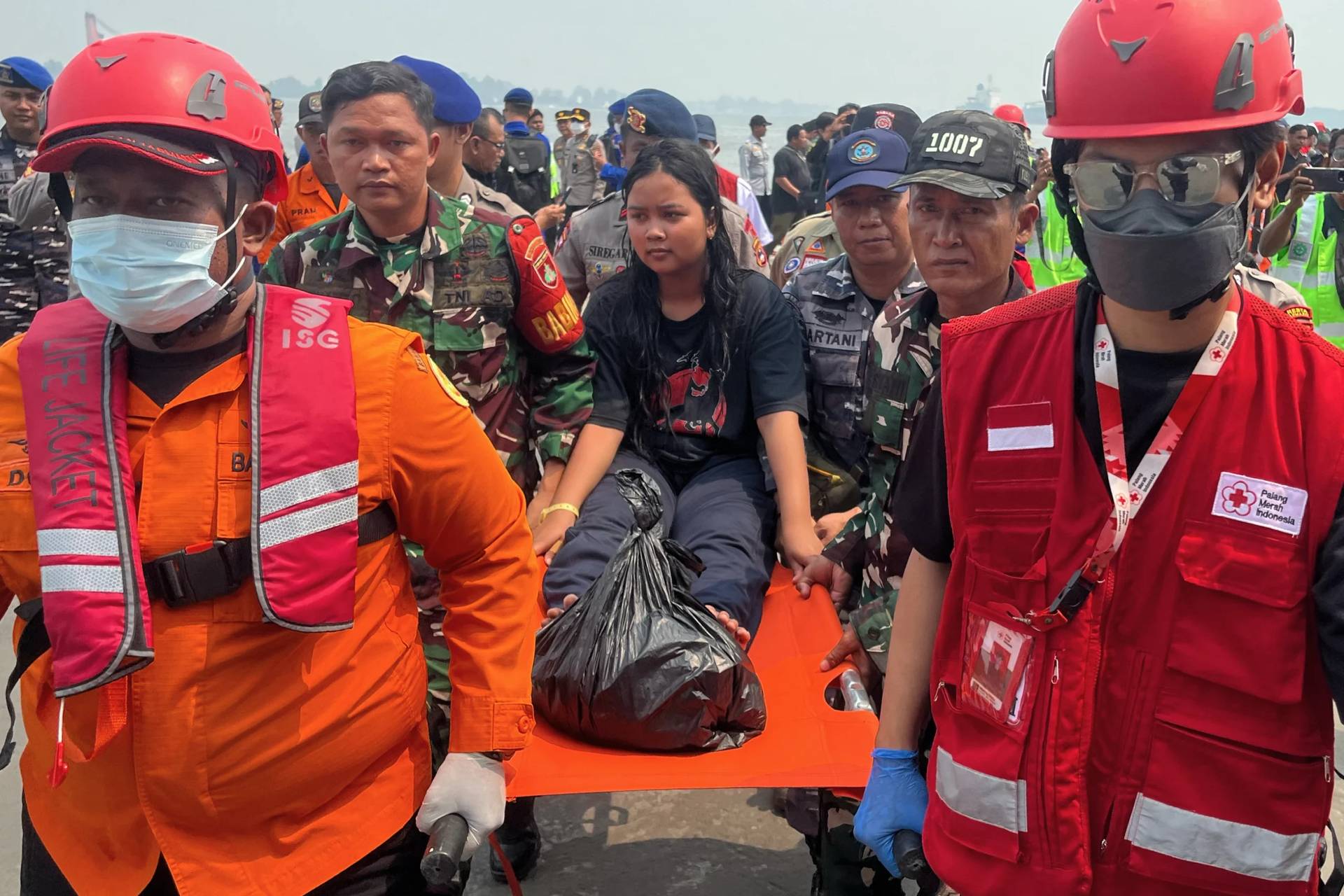 Rescuers carry a survivor from a passenger ferry overturned in bad weather in the Java Sea on a stretcher upon arrival at a port in Banjarmasin, South Kalimantan, Indonesia, Tuesday, Sept. 15, 2026. AP Photo/Iman Satria