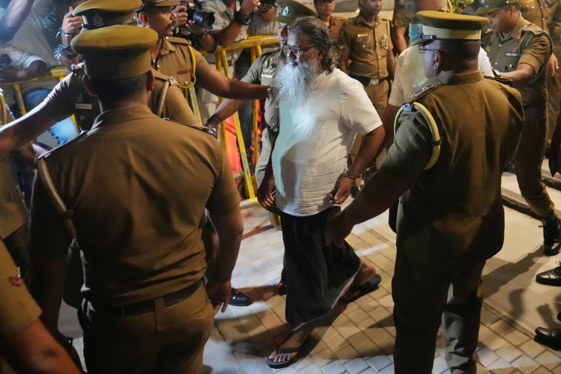 Unidentified men convicted for their involvement in the 2019 Easter bombings are escorted to a prison in Colombo, Wednesday, Sept. 23, 2026. (Credit: Eranga Jayawardena/AP.)