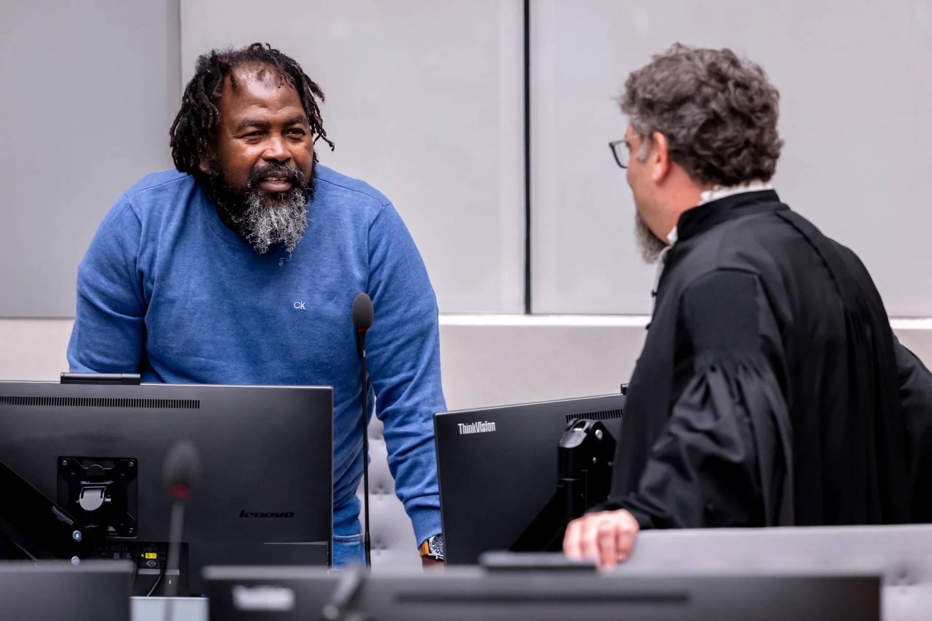 Seleka rebel group commander Mahamat Said Abdel Kani, left, speaks with lawyer Dov Jacobs in the courtroom during a hearing in the case in which he is accused of crimes against humanity and war crimes allegedly committed in Bangui in 2013, in The Hague, Netherlands, Wednesday, Sept. 23, 2026. (Credit: Remko De Waal/Pool Photo via AP.)
