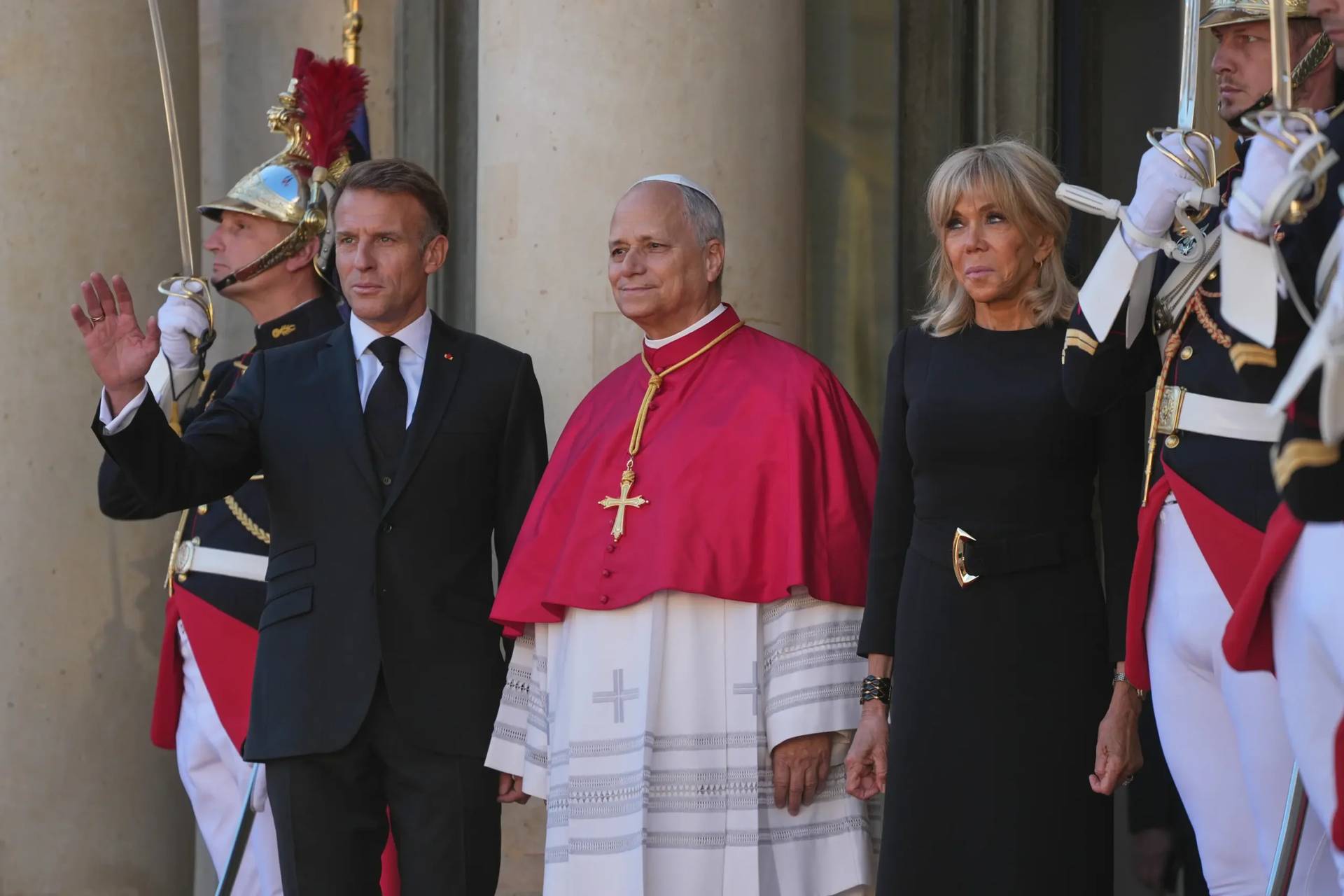 Pope Leo XIV, center, is welcomed by French President Emmanuel Macron, left, and his wife Brigitte as he arrives at the Elysee Palace in Paris, Friday, Sept. 25, 2026. (Credit: Gregorio Borgia/AP.)