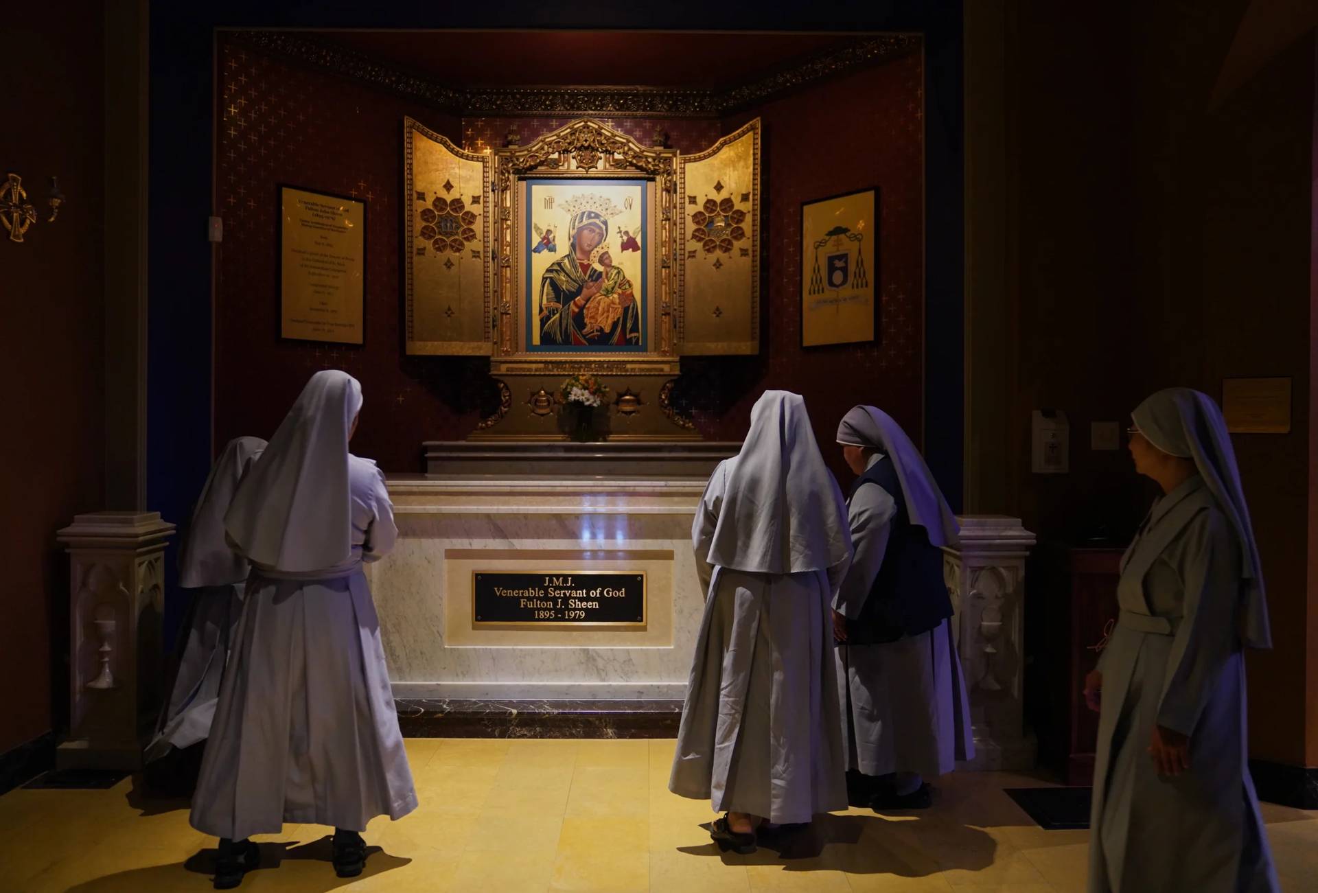 Nuns pray at the tomb of Archbishop Fulton Sheen at the Cathedral of St. Mary of the Immaculate Conception in Peoria, Ill., on July 15, 2026. (Credit: Jessie Wardarski/AP.)