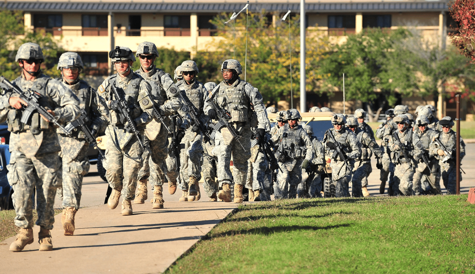 Soldiers from the 3rd Armored Cavalry Regiment storm the grounds of the Soldier Readiness Center to apprehend a mass shooter in Fort Hood, Texas, on Nov. 5, 2009. (Credit: David Morris/Killeen Daily Herald via AP/AP.)