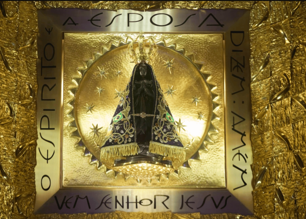 The statue of Brazil's patron saint, the Virgin of Aparecida, stands behind glass inside the basilica named after her in the town of Aparecida, Brazil, July 23, 2013. (Credit: Andre Penner/AP.)