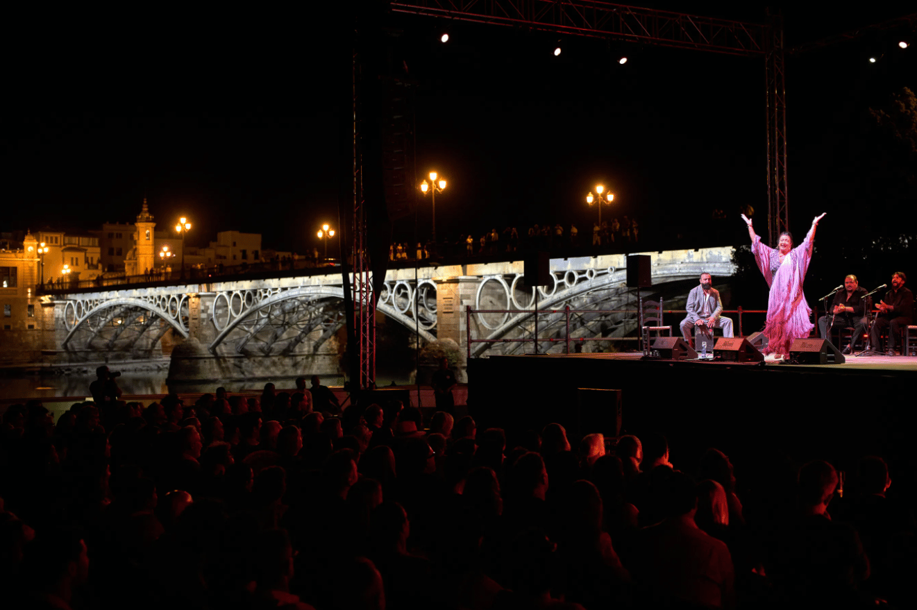 Flamenco singer Fabiola Pérez, known as “La Fabi”, performs on a stage next to the Triana Bridge during a concert organized as part of the Seville Flamenco Bienal in Seville, Spain, Thursday, Sept. 17, 2026. (Credit: Emilio Morenatti/AP.)