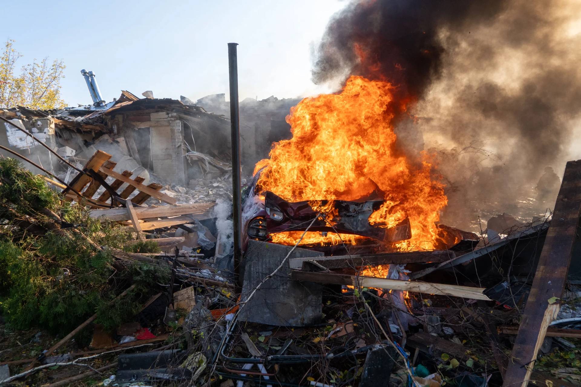 A car burns following a Russian strike on a residential neighbourhood in Kharkiv, Ukraine, Sunday, Oct. 11, 2026. (Credit: Andrii Marienko/AP.)