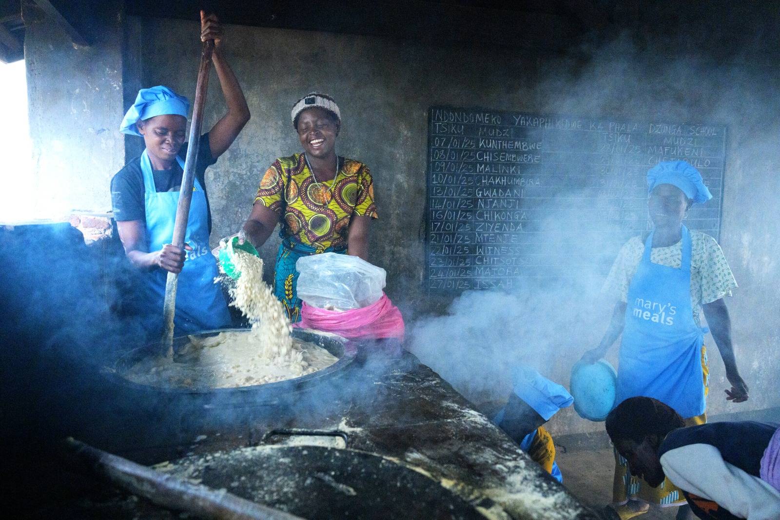 Women prepare porridge in Zambia. (Credit: Mary's Meals.)