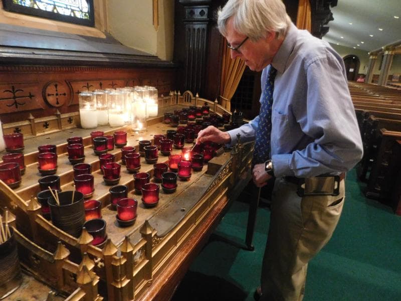 Faithful uphold the quiet tradition of lighting candles in churches