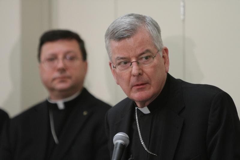 Ex-archbishop denies abuse claim, welcomes probe