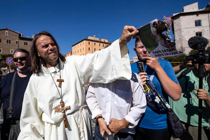 COVID deniers invoke Pope Benedict, burn image of Francis at Rome rally