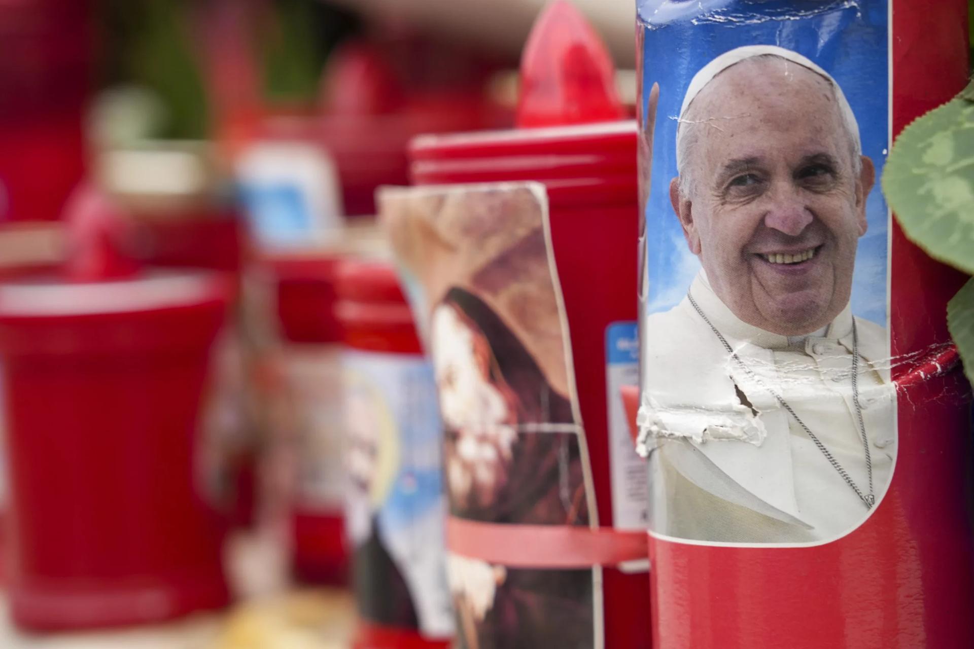 A candle with a portrait of Pope Francis is seen in front of the Agostino Gemelli Polyclinic, in Rome, Tuesday, Feb. 18, 2025, where Pope Francis has been hospitalised to undergo some necessary diagnostic tests and to continue his ongoing treatment for bronchitis. (Credit: Andrew Medichini/AP.)