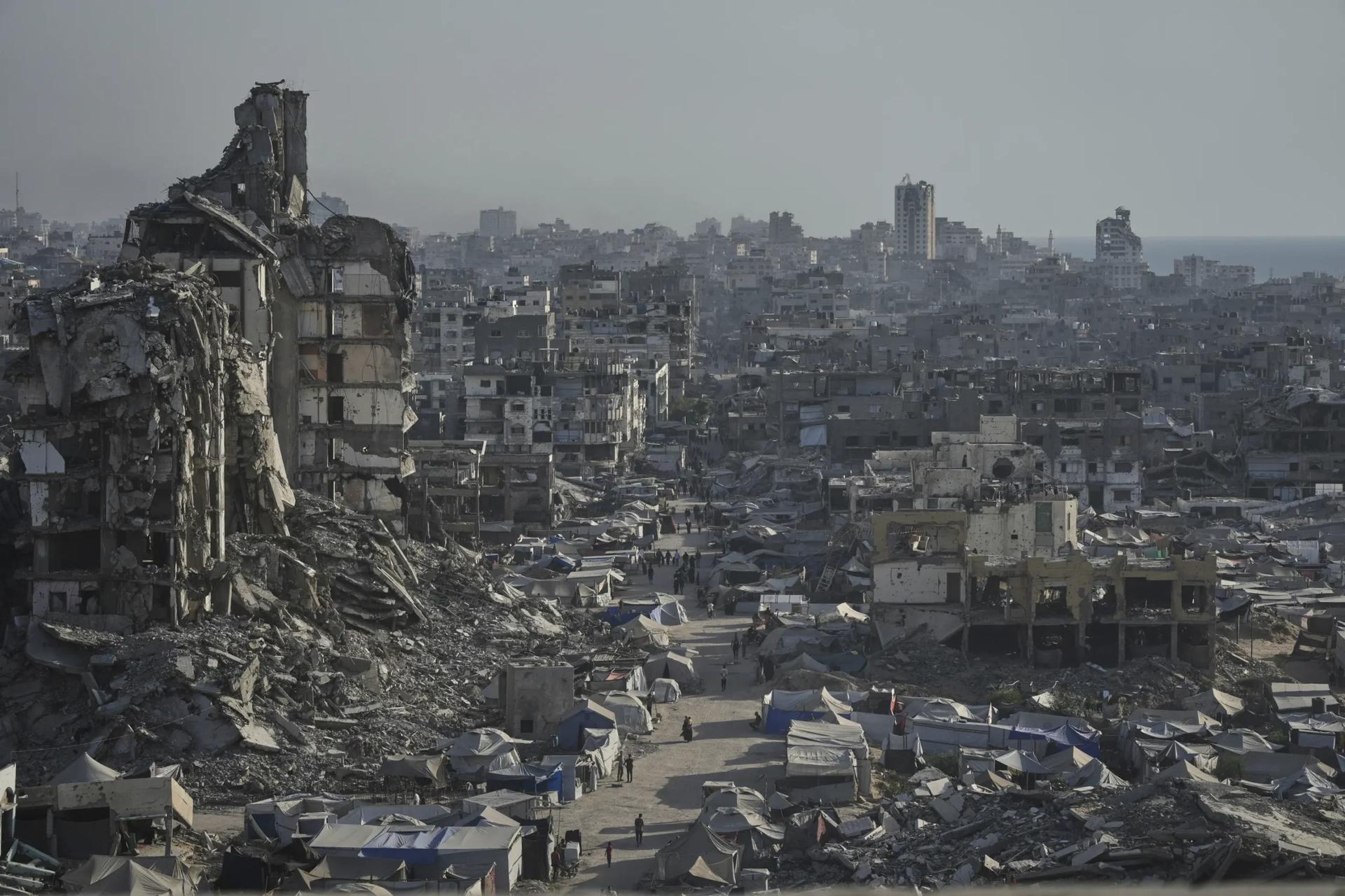 Tents sheltering displaced Palestinians are seen amid war-damaged infrastructure in Gaza City, Thursday, July 17, 2025. (Credit: Jehad Alshrafi/AP.)