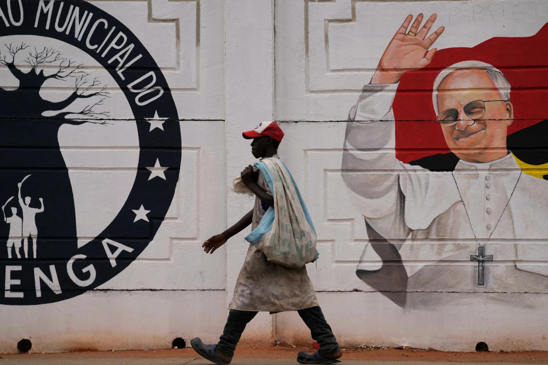 A man walks past a mural of Pope Leo XIV in Luanda, South Africa, Thursday, April 16, 2026. (Credit: Themba Hadebe/AP.)