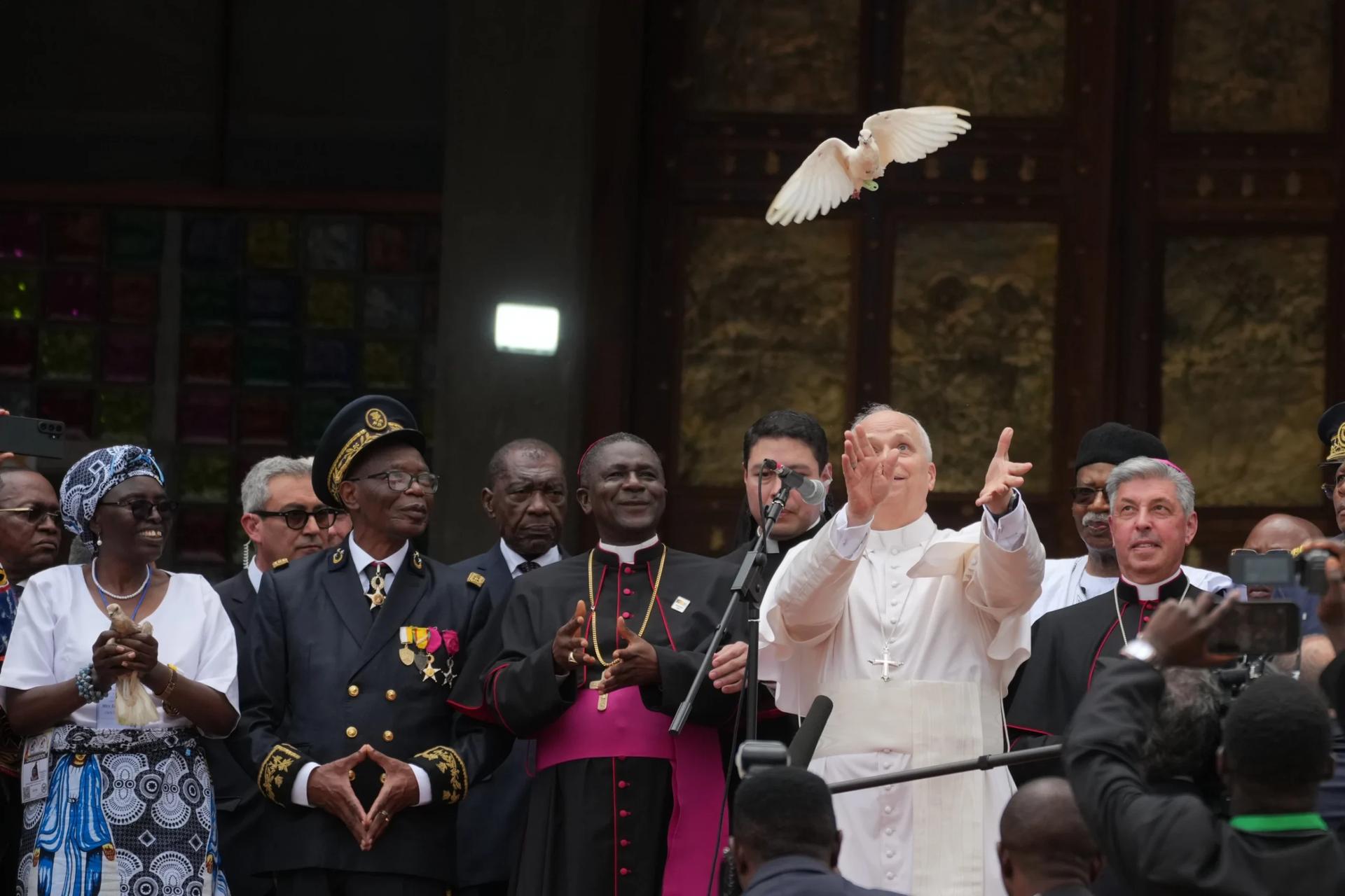 Pope Leo XIV, with the Archbishop of Bamenda, Andrew Nkea Fuanya, left, frees a white dove at the end of a meeting for peace at Saint Joseph’s Cathedral in Bamenda, Cameroon, with the local community Thursday, April 16, 2026, on the fourth day of his 11-day pastoral visit to Africa. (Credit: Andrew Medichini/AP.)