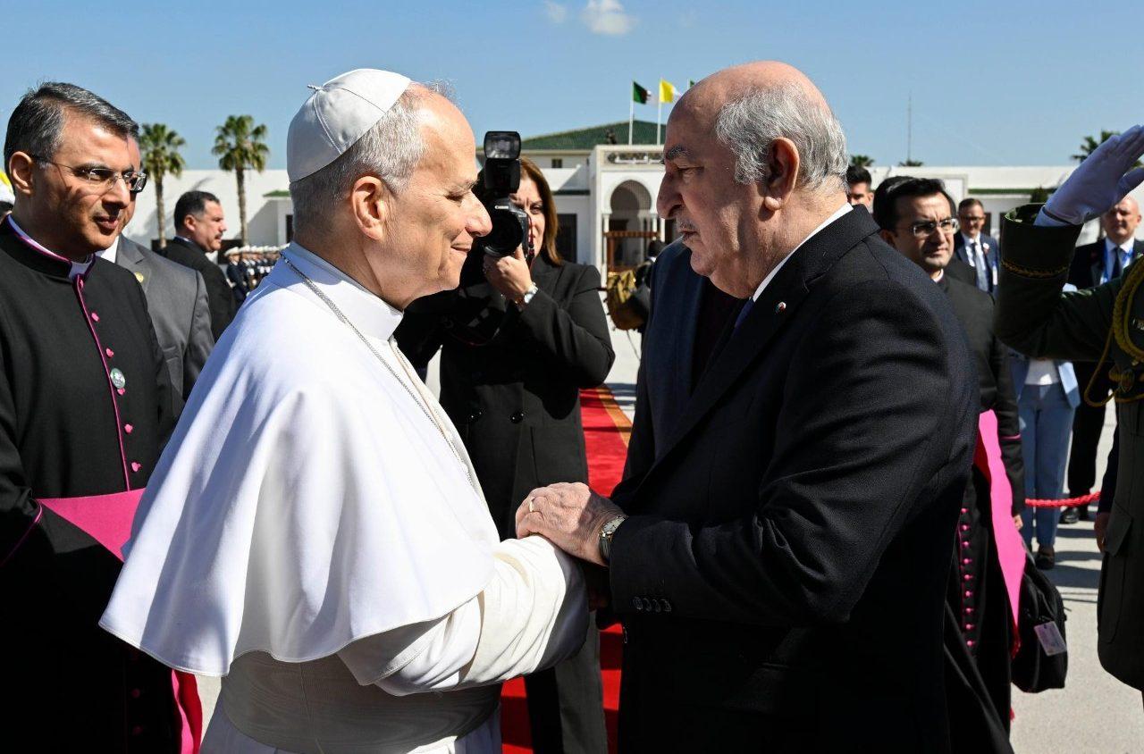 Pope Leo XIV shakes hands with Algerian President Abdelmadjid Tebboune on Algiers’s “Houari Boumédiène” International Airport on April 15, 2026. (Credit: Vatican Media.)